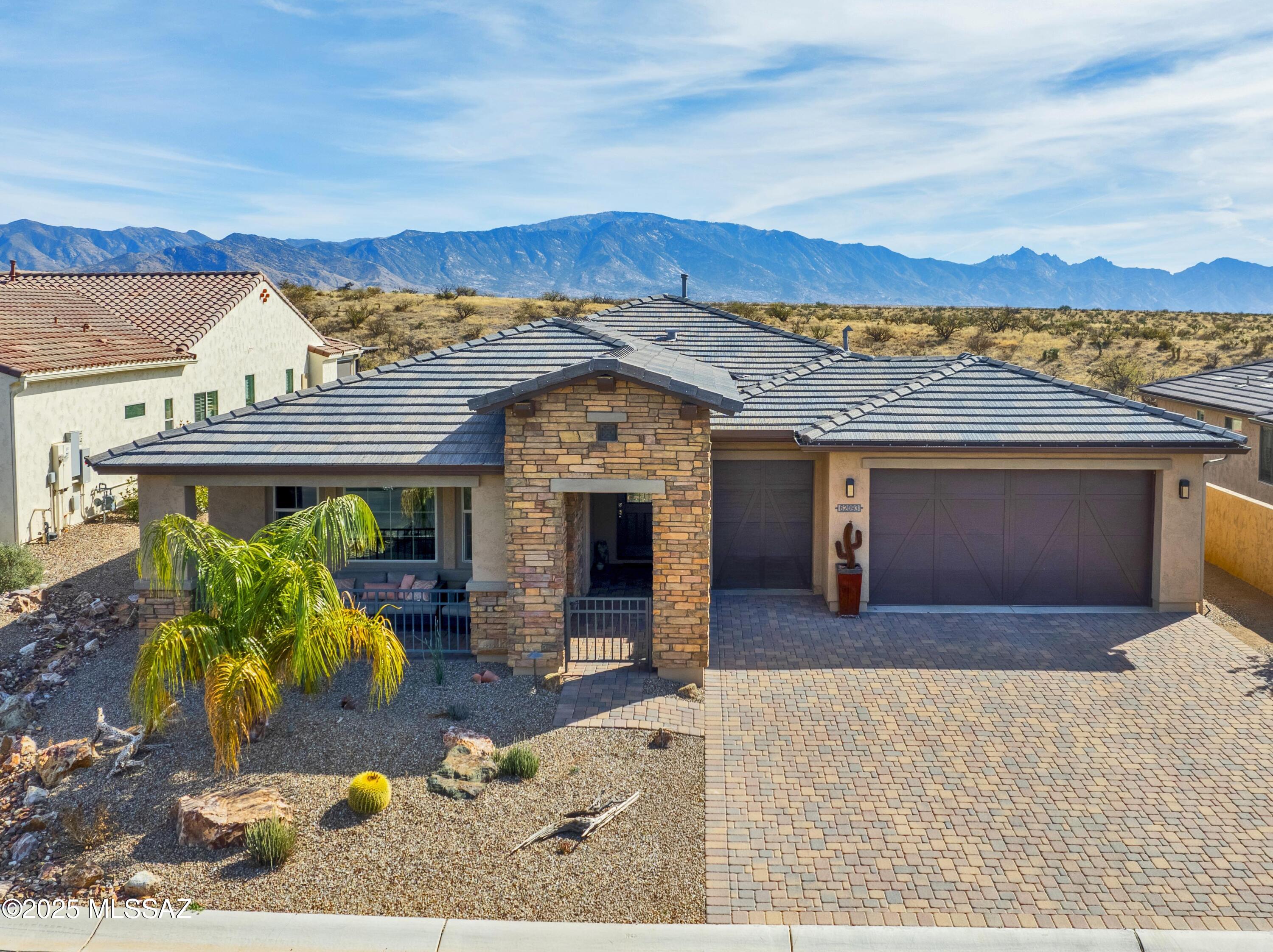 Breathtaking unobstructed panoramic mountain views can now be yours in this lovely Pavona model w/many outstanding features.  A dramatic stone covered front portico/porch welcomes you to this delightful retreat. As soon as you walk through the front door, the priceless view will immediately astound you from the Great Room, Dining Room, and Primary Bedroom.  The combination of natural light, practical spaces like the office/den or hobby room & hall desk area, plus the entertaining amenities such as the bocce ball court & extended covered patio, make this home both functional & inviting. The chef's kitchen, with its high-end appliances, gas cooktop, entertainment bar, walk-in pantry, and other thoughtful touches, is a dream for anyone who loves to cook or entertain.  The beautiful community of Saddlebrooke Ranch is nestled at the feet of the Catalina mountains.  A  resort-style active adult community, this vibrant haven boasts three on-site restaurants offering culinary delights to satisfy every palate. Residents can stay fit with access to a state-of-the-art indoor pool and fitness center, or take a refreshing dip in the large outdoor pool featuring a beach entrance and lap lanes. Golf enthusiasts will revel in the 18-hole golf course, while those with a competitive streak can enjoy the pickleball and tennis courts. The arts and crafts building is a creative paradise, complete with a woodworking shop, glass fusion kiln, sewing room, computer room, and library. For pet lovers, the dog park provides a space for furry friends to run and play. With scenic walking trails winding through the community, Saddlebrooke Ranch is truly a place where active adults can live their best lives, surrounded by luxury and endless opportunities for recreation and relaxation.