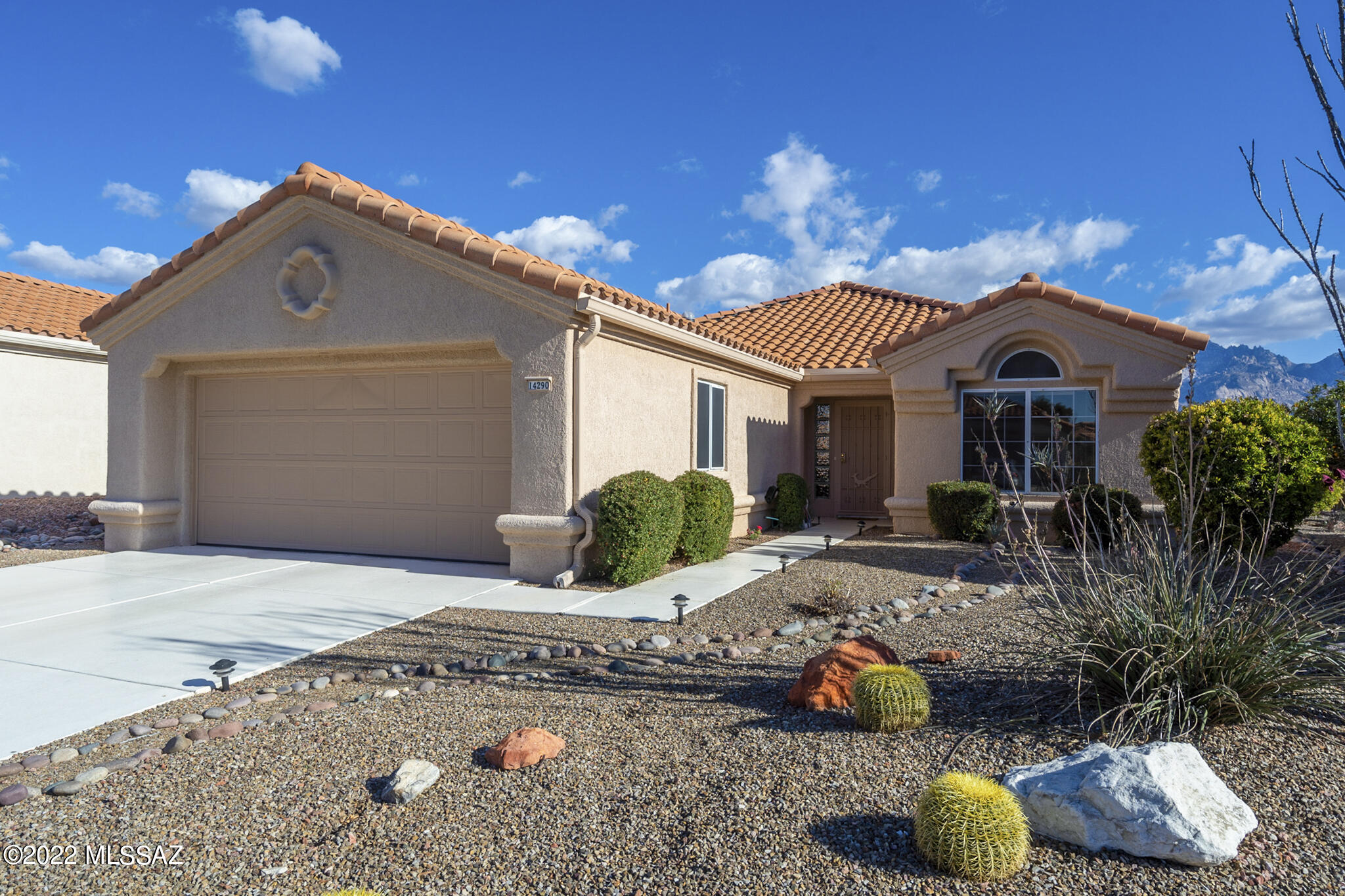 Views, views and more views are what you'll experience when you enter this well-kept, one-owner home in coveted Sun City Oro Valley! Popular Mariposa model has views from the kitchen, dining room, living room and owner's suite. A spacious living room invites you in with high ceilings, an abundance of natural light and a pass-through to the kitchen. Kitchen has quartz countertops, plenty of storage cabinets and pantry, plus a solar tube for extra, natural light. The split floor plan is hard to find and affords more privacy for you and your guests. Owner's suite offers en-suite bath with walk-in closet and another solar tube for natural light. You'll love the extended brick paver patio, showcasing extensive Catalina Mountain views, which can be accessed through sliding glass doors from the dining nook and also the owner's suite. Roof has been replaced, too, in this move-in ready home. Walk in, take in the beautiful setting and views  you'll fall in love with your new Sun City Oro Valley home!