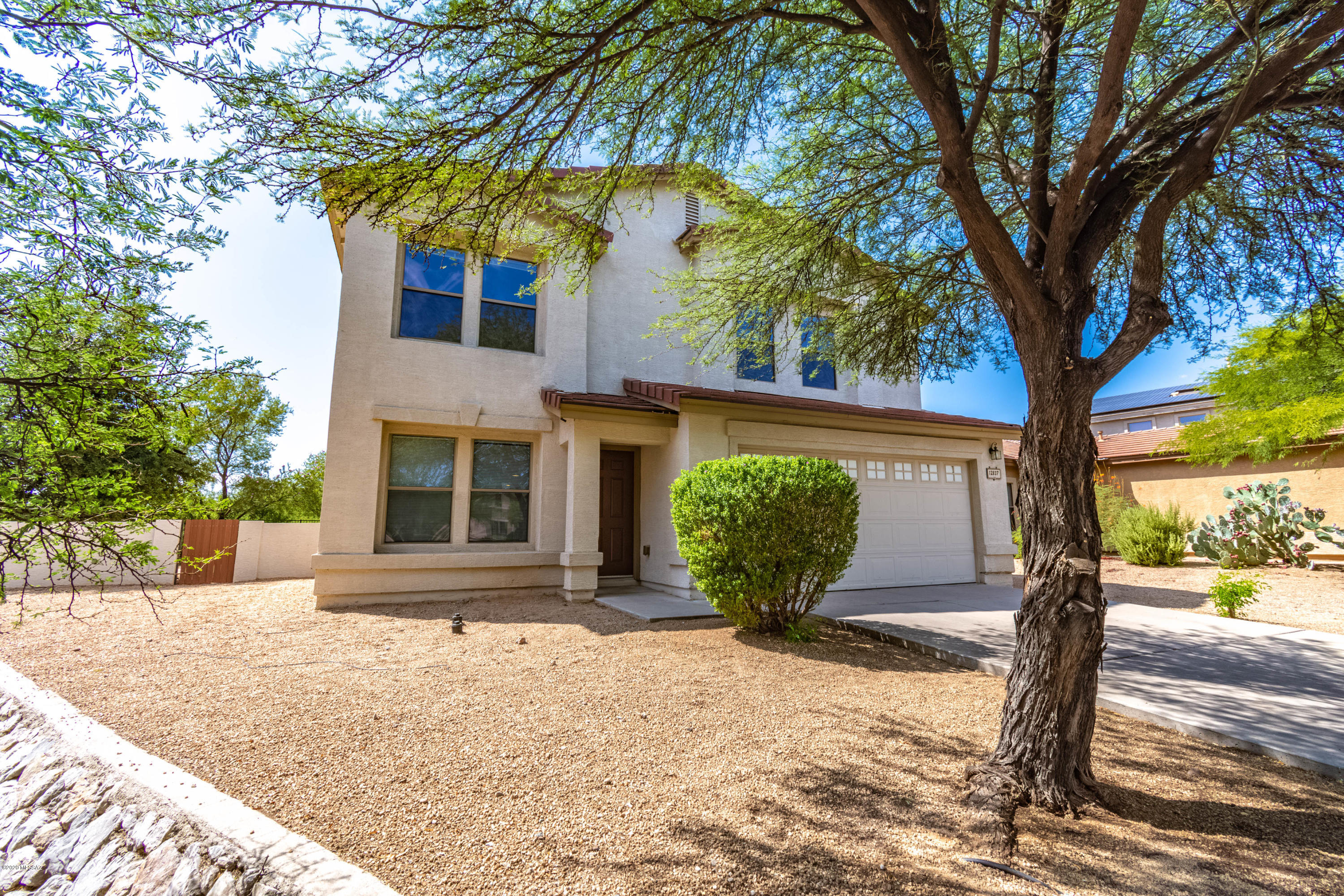 Move-in ready home  backs to wash with  views of mountains and sunsets. Updated,  modern paint.	Large ceramic tile flows throughout first floor.  Bright kitchen with  island/breakfast  bar & large walk-in pantry.   Floor plan  works with Multi-gen  with downstairs  bedroom & 3/4 bath  w/walk-in shower.  Open floor plan with Great Room and formal Dining/Living  areas. Large master,  3 bedrooms & loft upstairs. Master has double door entrance.  Expansive pool-sized  backyard has mature landscaping side yard and citrus  trees.  Wrought iron view fence  allows you views of the lush desert.   Deep covered  patio  for  outdoor relaxing. Nearby ammenities!