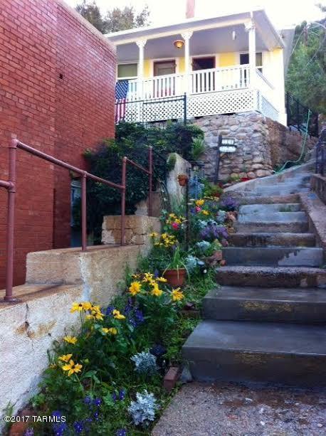 Seller entertaining offers between $149,900-$169,900 ~TWO Gorgeous, fully restored and equipped miner's cottages/vacation rentals - 2 Bedrooms each - in the heart of historic Old Bisbee. Sold as turn-key properties, these cottages feature stunning views, energy saving dual-paned windows and an eco-friendly on-demand hot water, as well as convenient keyless entries. Furnished Master Bedroom has sleigh bed, bathroom in 1st cottage has large walk-in shower, tub/Shower combo in 2nd cottage w/ complete kitchens in both. Living room includes flat screen TV.  Multiple decks are perfect places to relax under the turquoise sky. Outdoor shower and wrap-around patios offer a front row view of Bisbee’s beautiful lifestyle. Turn-key and ready for new owner!