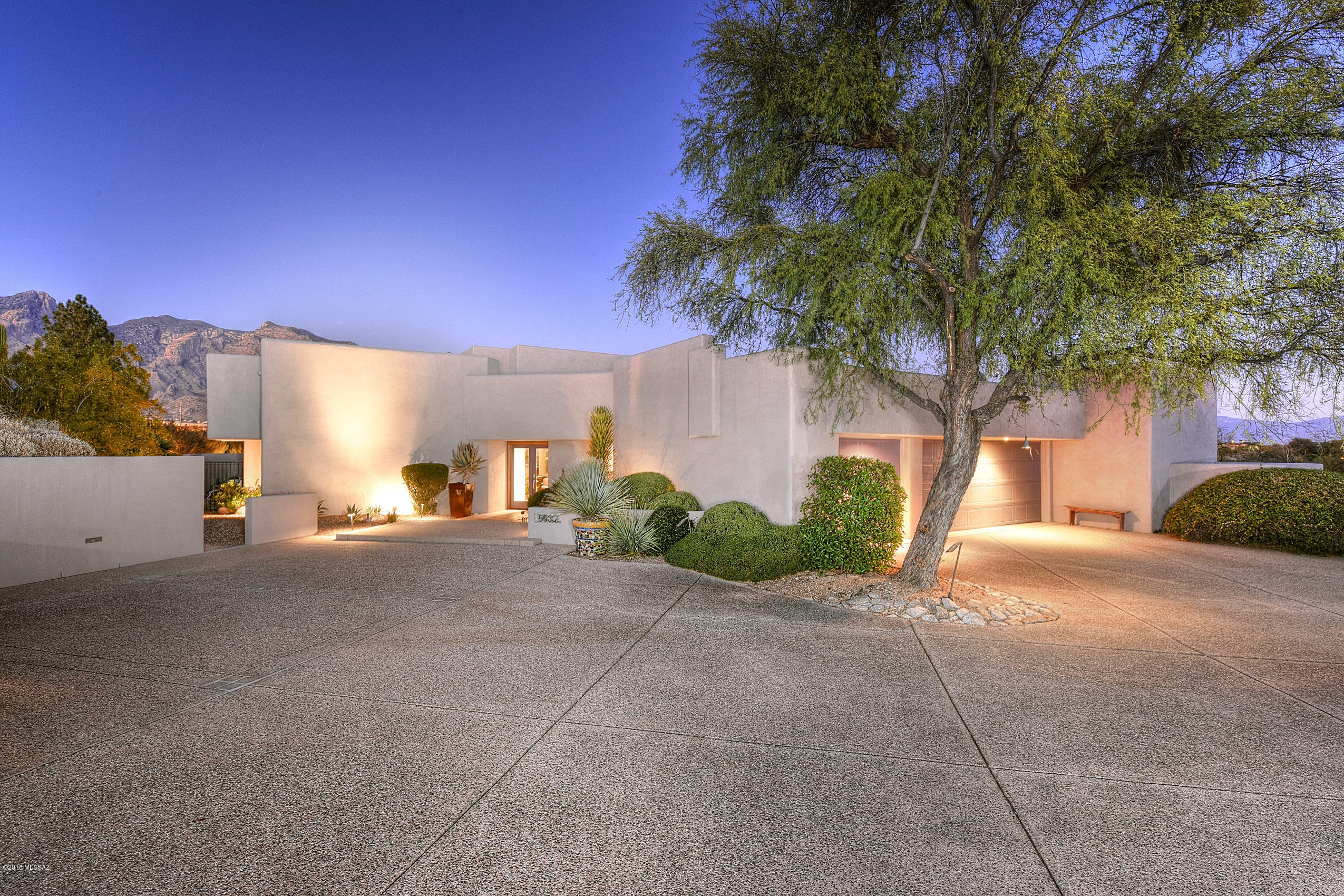 If you like Unique Architecture, high ceilings, interesting spaces, Stunning Views of the mountains & city lights, entertaining on your patio, Cooking in a gourmet kitchen w/ample space to create, this house is for you! Tyson/Murphy Architects built his gorgeous home w/its 1 bedroom guest house. The main house is 3240 sq ft w/a split floor plan- 2 bedroom, 4 bath, game room/exercise room that could easily be a 2nd master suite by just adding a door & a little drywall to enclose space for the closet. Dream Kitchen w/butlers pantry features granite counter tops, cherry cabinets, Dacor 5 burner gas stove w/stainless hood, 3 Fisher Paykel dish drawers, Stainless Dacor dual ovens, stainless subzero fridge & full sized GE 2nd fridge in Butlers Pantry. This home is private & has soaring ceilings with interesting lines/shapes, dual fireplace in living room/master bedroom and another fireplace on the back patio.  There are walls of windows everywhere with warm wood trim that is a signature Tyson/Murphy modern look/feel.  The outdoor entertainment area has everything you could want- pool, spa, fireplace, several separate patios with unique views. Guest house is 736 square feet, 1 bed, 1 bath, kitchen & has a private entrance so your guests can come and go as they please. This guest house also has killer views of the Catalina Mountains & City Lights.  Come take a look at this house, please call for appointment to view.