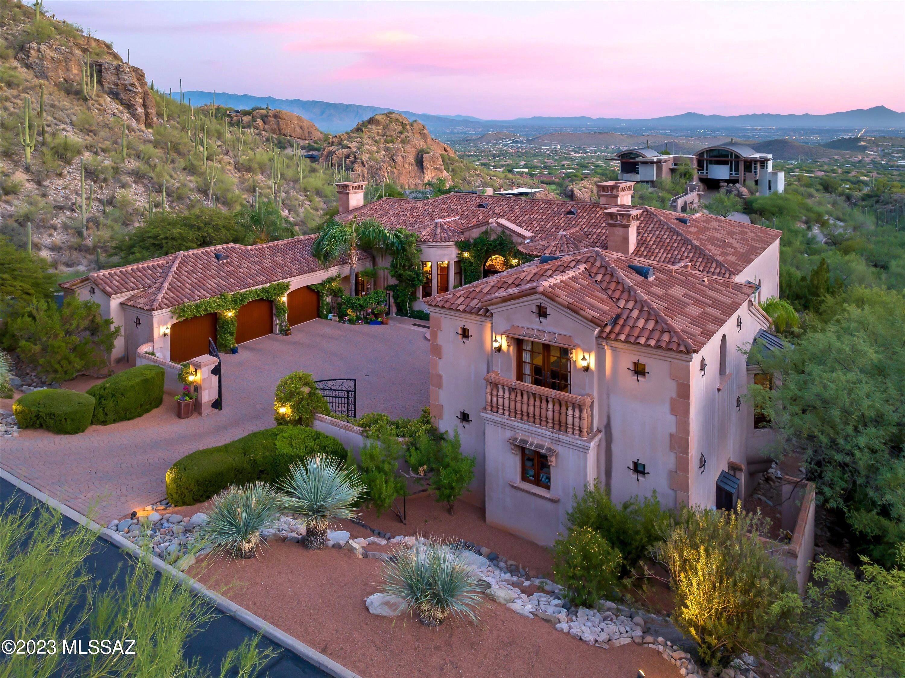 This stunning Foothills Mediterranean is the perfect blend of superb craftsmanship & detailed design, creating sophistication throughout. Constructed with stucco over masonry, this home is perfectly situated in the coveted, gated community of Ventana Canyon Mountain Estates, with the Catalinas are at your door to the north, city lights to the south and Ventana Canyon's premier golf course just down the street. Utilizing a mixture of warm wood tones, tile, concrete and natural stone, a beautiful and comfortable aesthetic is brought to life. A total of 6BR/8BA combine to bring this property to the forefront of a tranquil, exquisite home, with a Gourmet Chef's Kitchen, flanked by a Family Room and a formal Living Room/Dining area with magnificent city views. The Owner's Suite is a true retreat, featuring a spacious closet and a spa-like bathroom with dual vanities, walk in shower and a soaking tub. The den/library provides that sanctuary for a great book, with a separate office just steps away. A massive, bonus room/game room resides downstairs, along with a W/D, mini fridge, sink, fireplace and 3BR/ 2BA, providing the perfect space for family members' day to day activities. Two, separate guest quarters, each containing a bedroom, full bath and sink/fridge area provide guests with privacy. A southern oriented yard with pool, dedicated ½ bath and large patio creates a beautiful, European style oasis. Completing this stunning estate, for the auto enthusiast, there are separate 2 and 3 car garages. Close to restaurants, shopping and Ventana Canyon's premier golf course, this dramatic home is a must see!