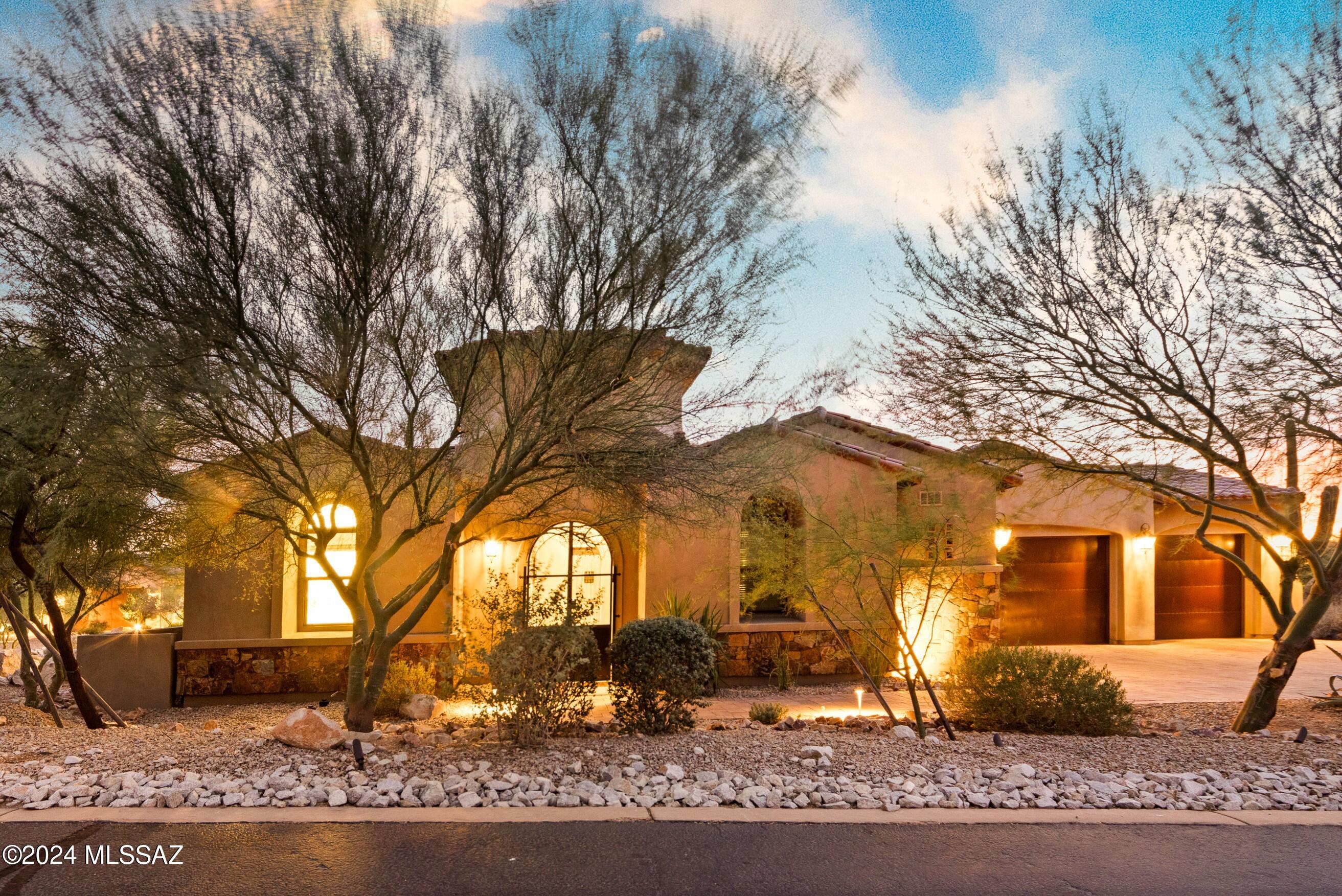 Luxury living in Stone Gate within the prestigious guard-gated community of Stone Canyon, Oro Valley. This stunning single-story 3,674sf home has 3BR/3½ BA home plus den, game room & office. Enter through enclosed courtyard & step into an open concept living space w/soaring ceilings. The private low-maintenance backyard has artificial turf, BBQ & fire pit. The Patio has electronic shades allowing year-round enjoyment. The kitchen is a chef's dream, featuring beautiful granite countertops, stainless appliances, extensive cabinetry w/under cabinet lighting, walk-in pantry & large island perfect for entertaining. Enjoy casual meals in the dining nook or host formal dinners w/built-in buffet & wine cooler. The great room's stacked stone fireplace & expansive collapsing glass doors invite the serene desert into the home. The master suite is a private retreat with a spa-like bath, soaking tub & large walk-in closet. Additional bedrooms offer privacy on the opposite side of the home. Plus, a converted 4th 252sf garage with mini-split serves as office with built-in desk or home gym. Just minutes from Stone Canyon's Clubhouse and Championship Golf.