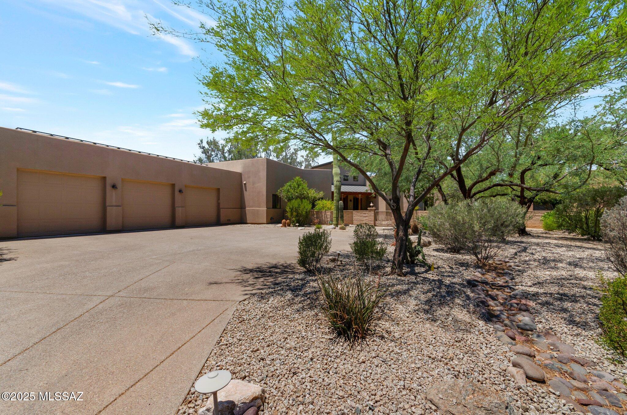 This meticulously maintained three-bedroom, three full-bathroom home features an inviting front courtyard overlooking Parade Ground Park. The main living space is enhanced by tall ceilings, a gas fireplace, a generously sized kitchen, and spacious den. The laundry room includes a sink, cabinets, and ample counter space. The oversized three-car garage offers abundant storage. A covered breezeway connects the primary home to a well-appointed guest house, which includes one room, one bathroom, a sink, a compact refrigerator, and a walk-in closet, ideal for guests or multi-generational living. The backyard is designed for entertaining, featuring a heated spool for year-round enjoyment. With low solar energy costs, this property combines luxury & comfort in a highly desirable gated community.