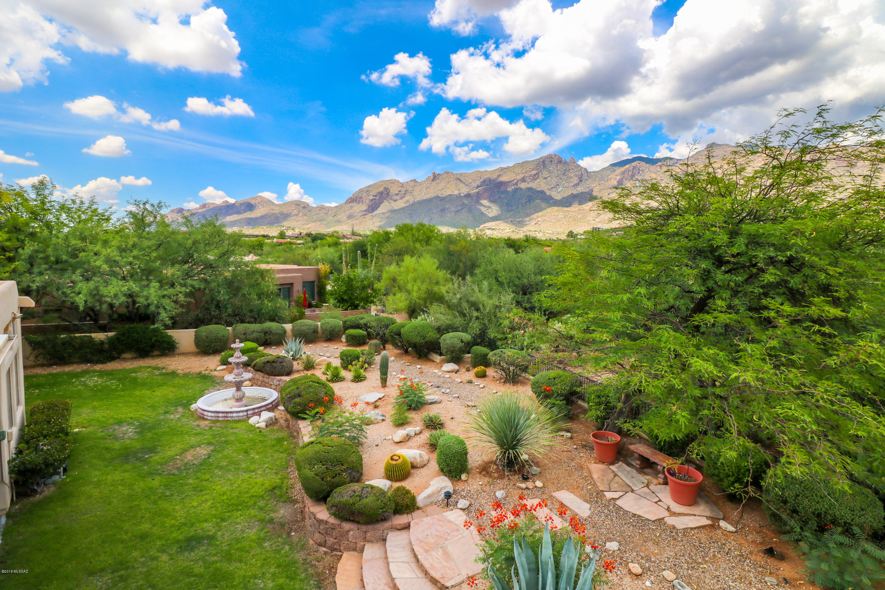 Unbelievable mountain AND golf course views from this stunning home in prestigious La Paloma Ridge Estates! Highly desirable location with manned guard gate & situated on a quiet cul-de-sac. The perfect open floor plan- master split from spacious guest rooms & soaring high ceilings throughout! Kitchen opens to family room with fireplace. Travertine floors & high end finishes throughout! Gourmet kitchen with new cabinets w/ pull outs, double ovens, new backsplash, granite countertops, gas range, and stainless steel appliances! Screened AZ Room is bonus living/entertaining space! Backyard is completely private with one of the most impressive screened in Arizona rooms you've ever seen! Low care backyard with unobstructed views of Finger Rock. Absolutely perfect house, this one is a MUST SEE!
