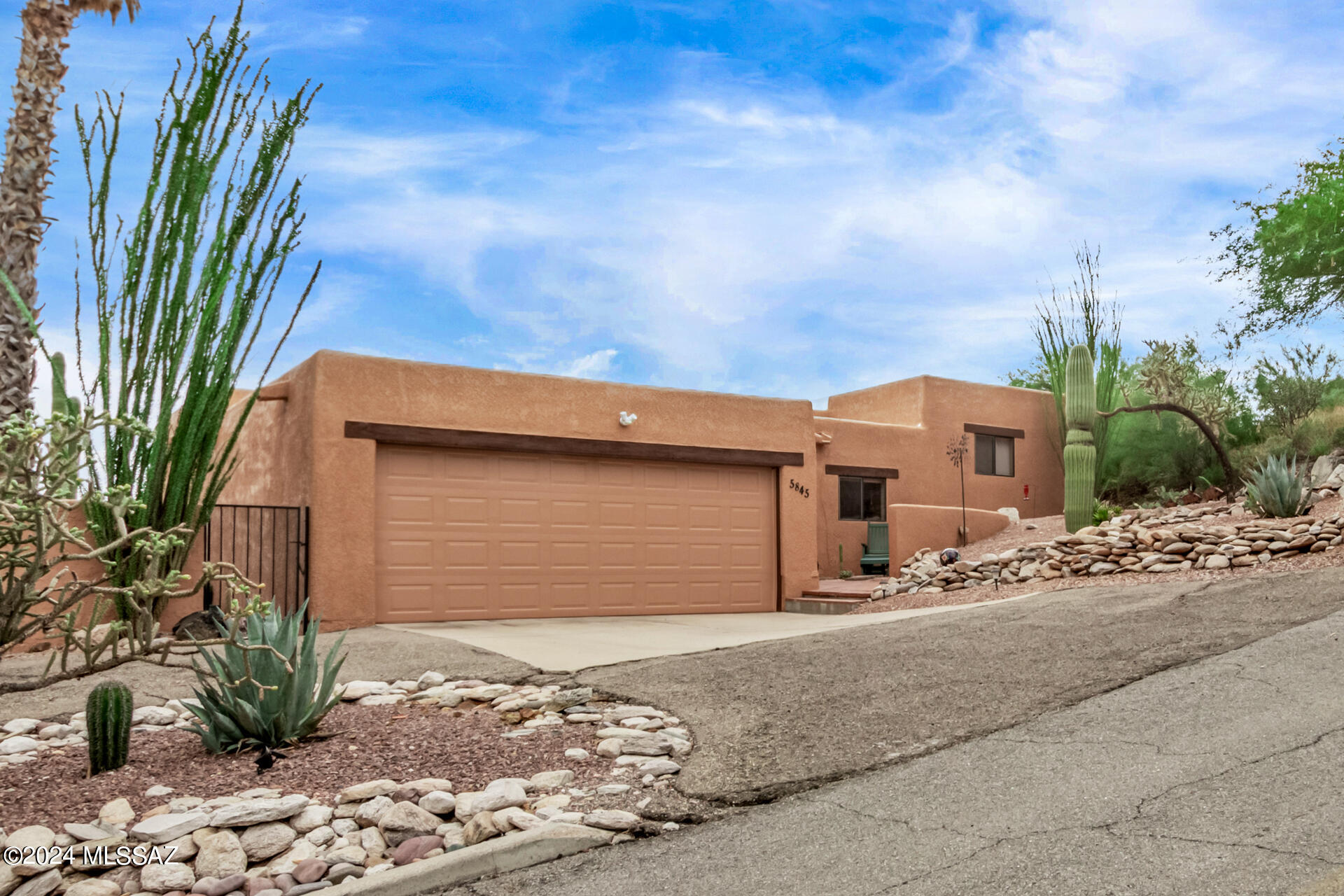 Stunning hillside property featuring gorgeous curb appeal in Tucson is the one you've been looking for! Fall in love w/an enchanting interior showcasing vaulted ceilings adorned w/exposed beams, a soothing color palette, tile flooring, & a delightful wood-burning fireplace. Discover the fabulous wet bar perfect for hosting fun get-togethers! The beautiful gourmet kitchen boasts wood cabinetry w/crown moulding, granite counters, sparkling SS appliances, a chic mosaic backsplash, & an island equipped w/a breakfast bar. The main suite features private outdoor access, an immaculate bathroom w/dual sinks, & a walk-in closet. Enjoy relaxing along w/your loved ones in the serene backyard, offering a charming deck w/great views & a refreshing swimming pool w/a spa! This gem won't disappoint!
