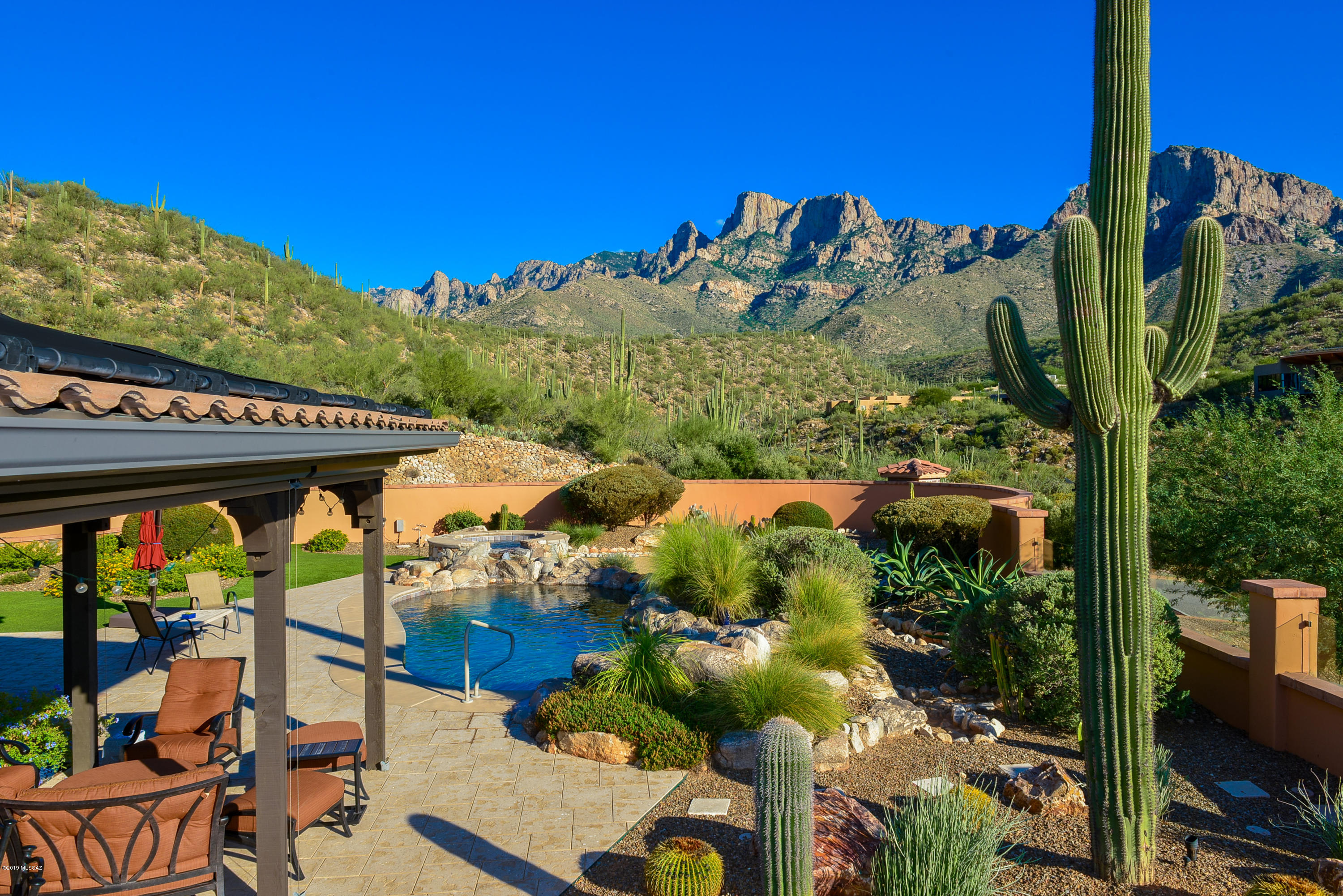 Incredible unobstructed mountain views from sunrise to sunset. This semi custom home located in Ponticello in the gated community of La Reserve will not disappoint as you enter through the gated courtyard to the custom front door.  This very special home hosts a great room concept with gas fireplace,  dining room with wet bar and wine refrigerator, Gourmet kitchen with granite counter tops, custom cabinets with pull outs, sit up bar, and kitchen nook. Spacious master bedroom with remote controlled curtains, master bath with walk in shower,  double vanities, granite counter tops, garden tub,and walk in closet. En suite guest bedroom with full bath and sliding door to the gated courtyard, den/office media room. Incredible backyard with heated salt water pool and spa. Wood burning firepit
