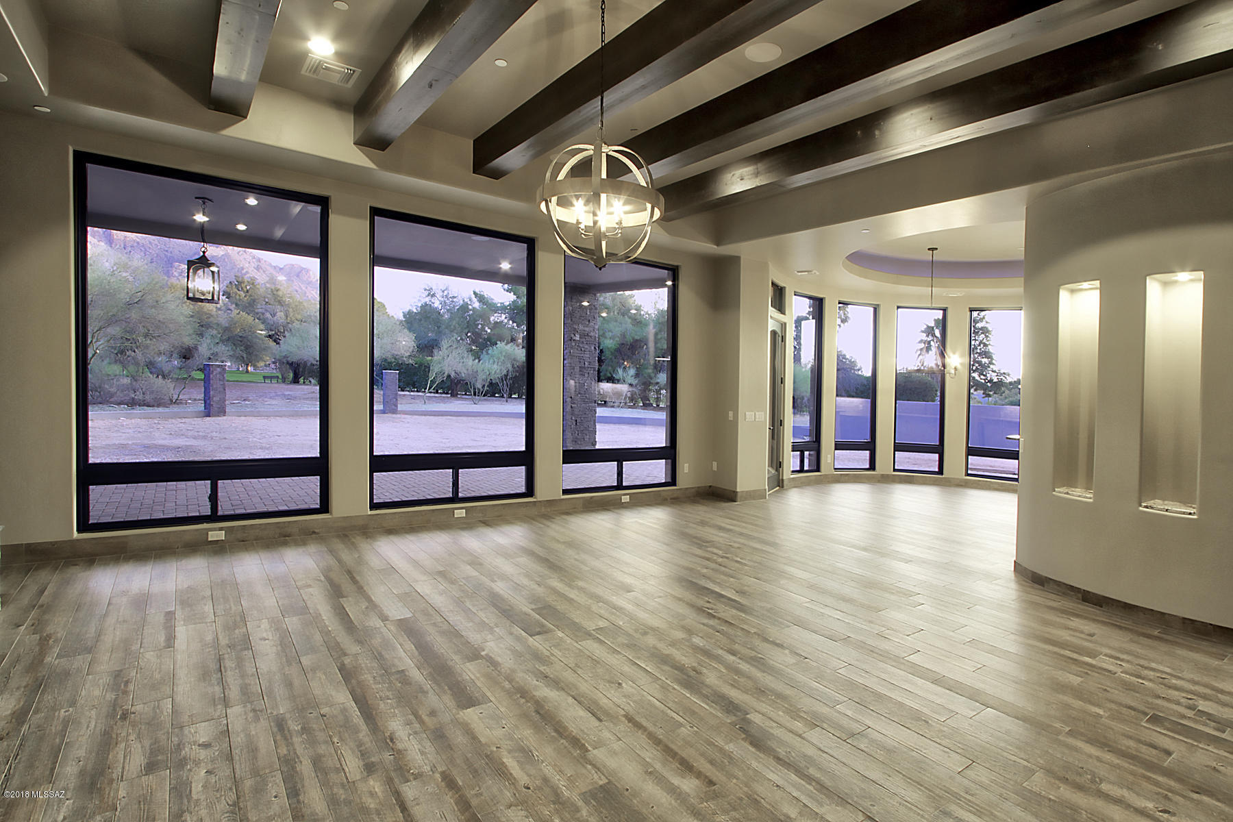 New Custom Home  in Sunset Canyon Estates.  Fabulous custom floor plan features Open great room kitchen, dining,and glass surround kitchen nook. Huge wraparound rear patio captures view of Pusch Ridge from premium .84 acre lot.  5 bedroom plan en suite baths, walk in closets, Den and exercise room. Sunset Canyon estates is located in the heart of Oro Valley, near shopping, medical, and walking distance to Wilson K-8. Call to learn about all the new home options available. This custom home can also be built on your lot. Call for details. Photos are of this floor plan built previously.
