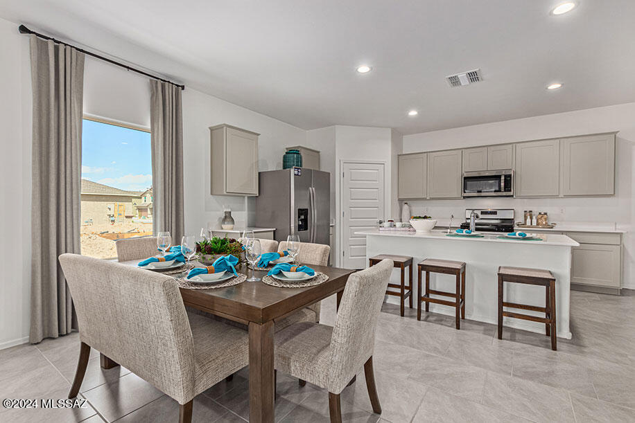 Welcome to Senita Crossing, where spacious living meets convenience! Our newest Tucson community boasts this open floor plan ideal for modern living. Enjoy the perks of a community park just steps away, with easy access to I-10, DMAFB, TIA, University of Arizona, and Downtown Tucson. Inside, you'll find a host of premium features, including stainless steel appliances (microwave, dishwasher, gas range), walk-in pantry, white shaker cabinets, granite countertops, and tile flooring in most areas. Say goodbye to cold showers with a tankless water heater and embrace the future with smart home technology. Plus, enjoy the convenience of water filtration at the kitchen sink and the added efficiency of a radiant roof barrier. Don't miss out on the opportunity to make Senita Crossing your new home