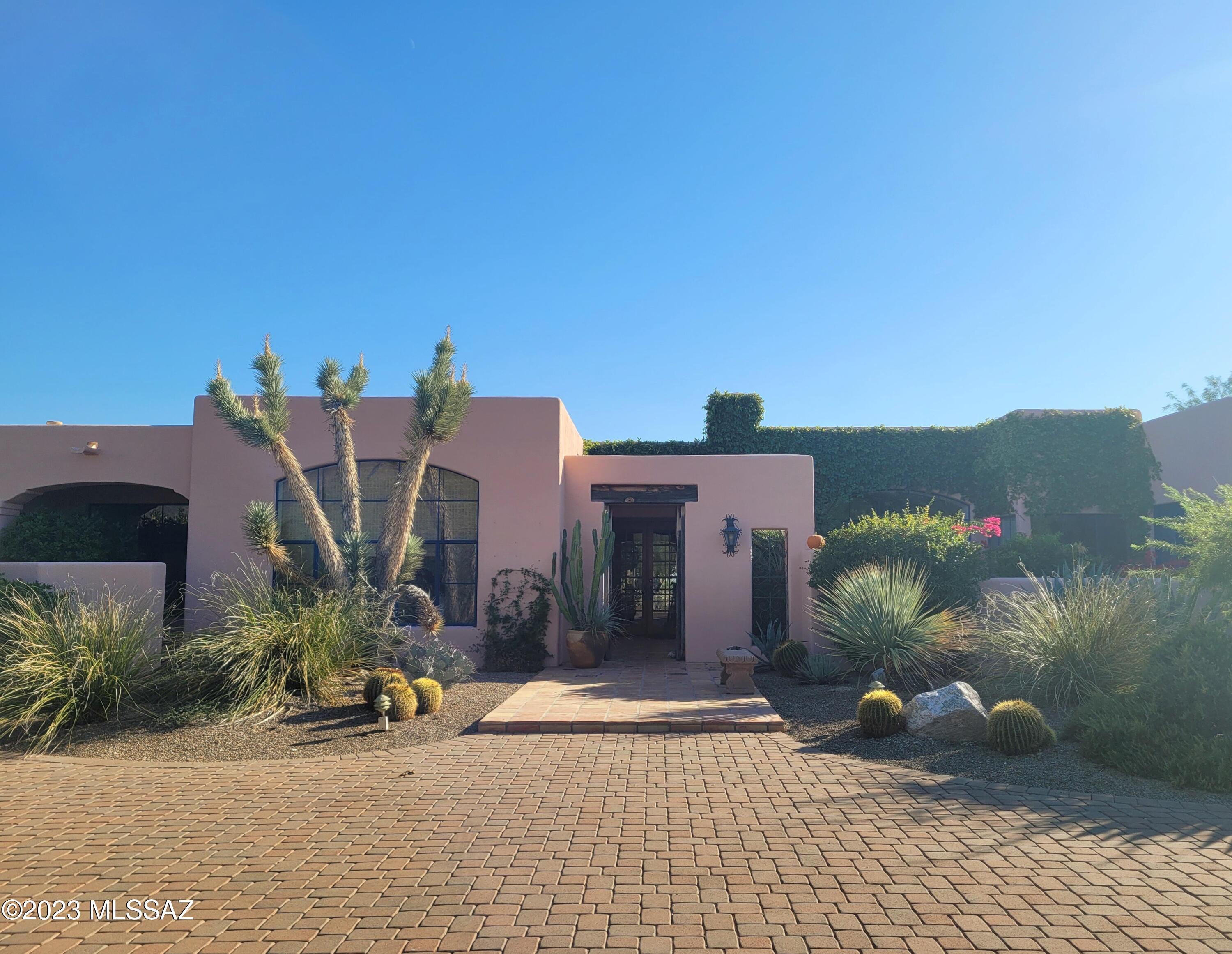 This Beautiful Home located in the desirable Catalina Foothills Estates offers stunning views of the Catalina mountains from the front and sparkling city views from the back. Built by Bart Marshall, the unique features of the saguaro rib doors, exposed wood beamed ceilings and Saltillo tile throughout infuses this home  with southwest flare. The private backyard oasis has a large covered patio, built in BBQ, pebble tec pool and outdoor shower.