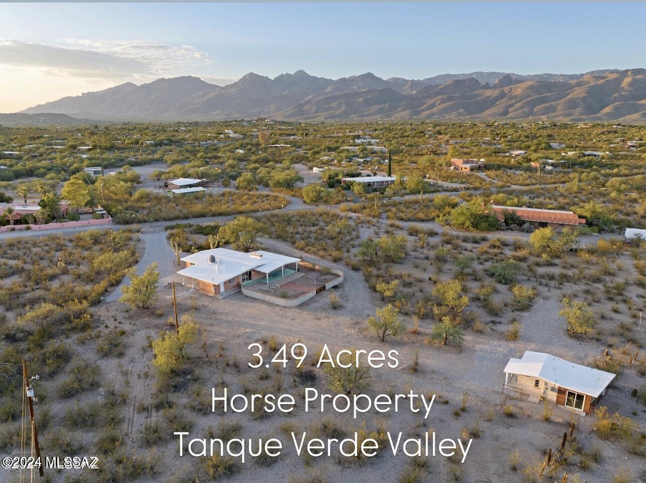 Discover the perfect blend of vintage charm and modern living in this stunning mid-century home situated on 3.49 acres in the desirable Tanque Verde Valley. With a classic red brick exterior, this property offers a unique multi-generational layout featuring 4 spacious bedrooms and 2 baths in the main house, along with a delightful 1-bedroom, 1-bath casita, ideal for guests or extended family.
Step inside to find a beautifully updated interior that boasts custom tile work and elegant cabinetry. The home features Two fireplaces, no carpet for easy upkeep, and the gourmet kitchen is adorned with luxurious stone countertops and new appliances; making it a chef's dream. The bathrooms offer new vanities and luxurious granite countertops, adding a touch of sophistication.