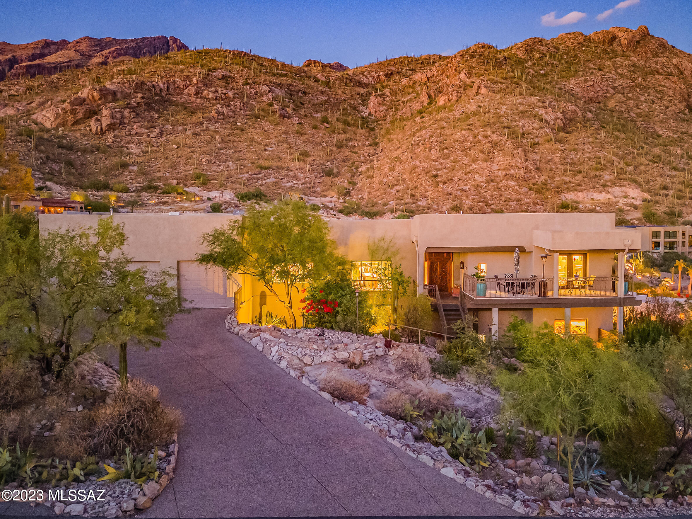 Carved from the very stone of a high ridge in the prestigious Coronado Foothills Estates, this residence boasts breathtaking panoramic city and mountain views from almost every window. High ceilings and natural light flood the living spaces with the serenity and natural beauty of the Sonoran Desert. A multitude of patios, balconies, and tranquil multi-level hideaways create a sense of isolation and privacy, yet you are only minutes away from country clubs, shopping, schools, and golf. A quick climb to the rooftop deck will immediately remind you just how conveniently located this magnificent residence is for the lifestyle you choose. Thoughtfully designed with privacy in mind, the master wing with sitting room and adjacent 2nd bedroom and bath are on the main level, shared with the great room and expansive kitchen. High quality appliances fill the kitchen and large laundry.  Below, you will find 3 more guest bedrooms and 2 bathrooms. The family room's rockface wall provides evidence of this home's unique character. The private studio is the perfect place to express the inspiration you feel when calling this residence your new home!