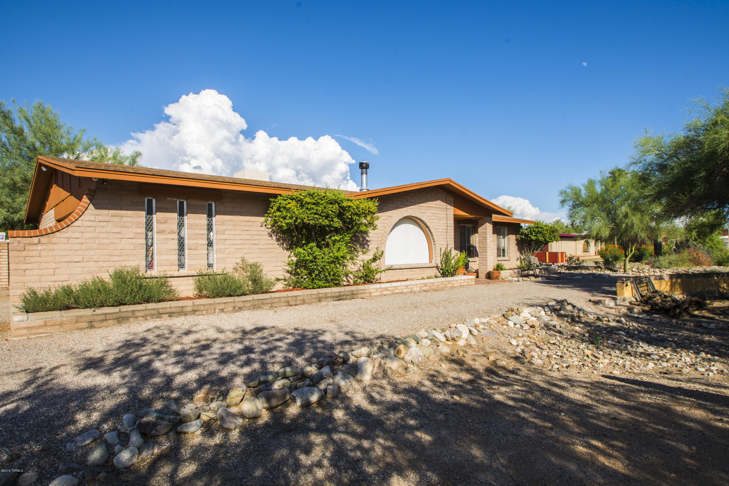Here is your opportunity to own a home in beautiful, quiet Rancho Feliz. This home, situated on over a half acre, features stunning views of Pusch Ridge complimented by gorgeous Tucson sunrises and sunsets. The large yet secluded backyard is the perfect setting for all your family get-togethers. With plenty of greenery, covered patios, a Ramada, a chiminea, and a wonderfully crafted custom pool; guests are sure to enjoy this oasis in the desert. Inside; this home features a traditional 3 bedroom, 2 bath floor plan with all new paint and beautifully renovated kitchen and bathrooms. Impeccably cared for saltillo tile lines the entry, hallways and common areas of the home. New cabinetry, counter tops, vanities, recessed lighting and many more modern features await within this southwest ranch.