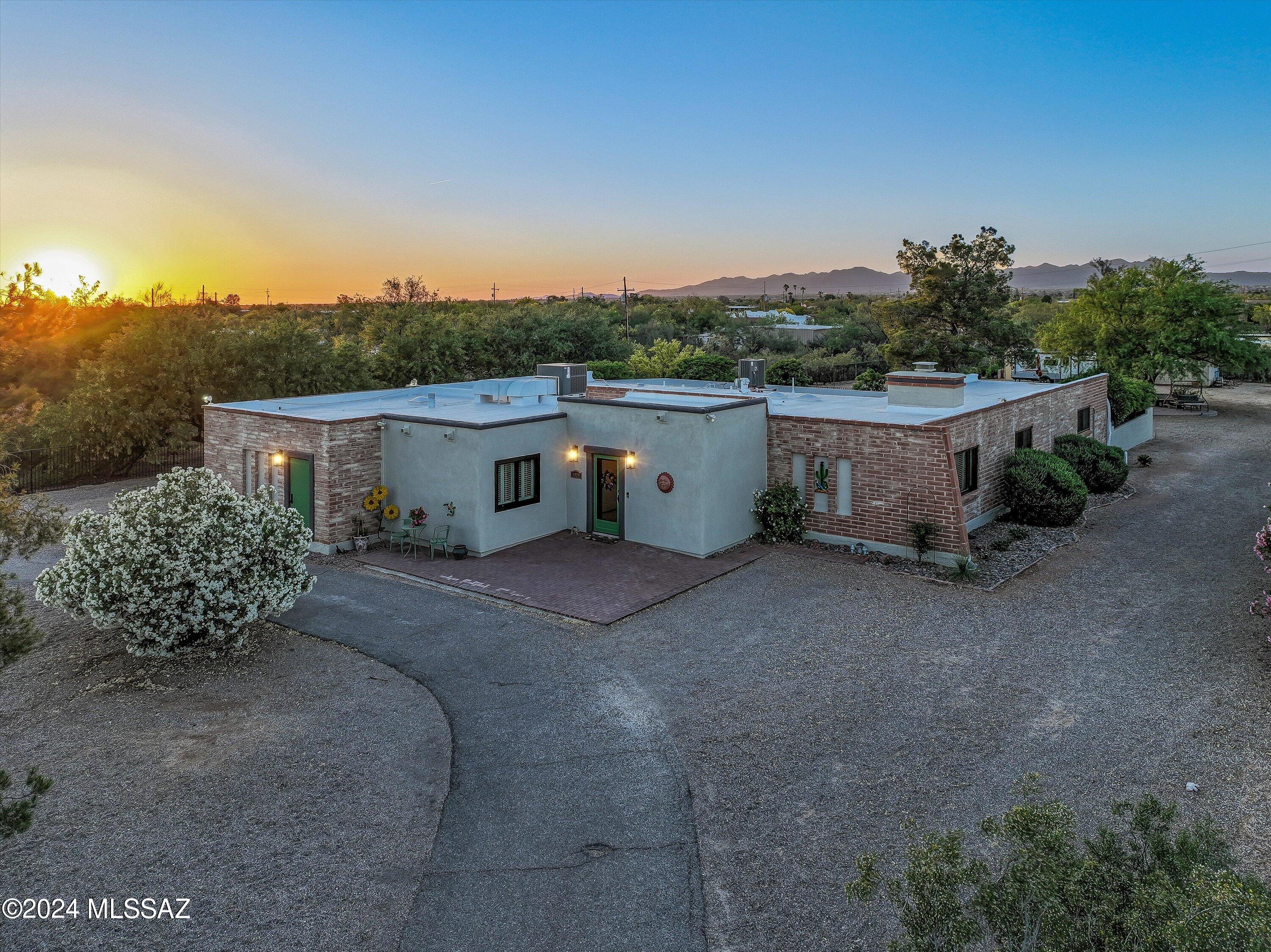 Exceptional privacy and plenty of space on this.825 acre property in fabulous NW location. Split-bedroom floorplan offers 4 bedrooms plus flex room/den. Second primary suite has separate entrance. The inviting interior features exposed brick, fireplace, travertine floors, granite counters, stainless appliances, and lots of storage. Major maintenance items have also been taken care of in the last year, including new Anderson windows and sliding doors, two new HVAC units, new irrigation system and more. Property is fully fenced, with circular driveway, plenty of room for RVs or toys, and a backyard that includes fabulous, courtyard entertainment space, two workshops/separate storage w/ lots of electrical power and tons of room. Oh, and lots of mountain views from the yard!