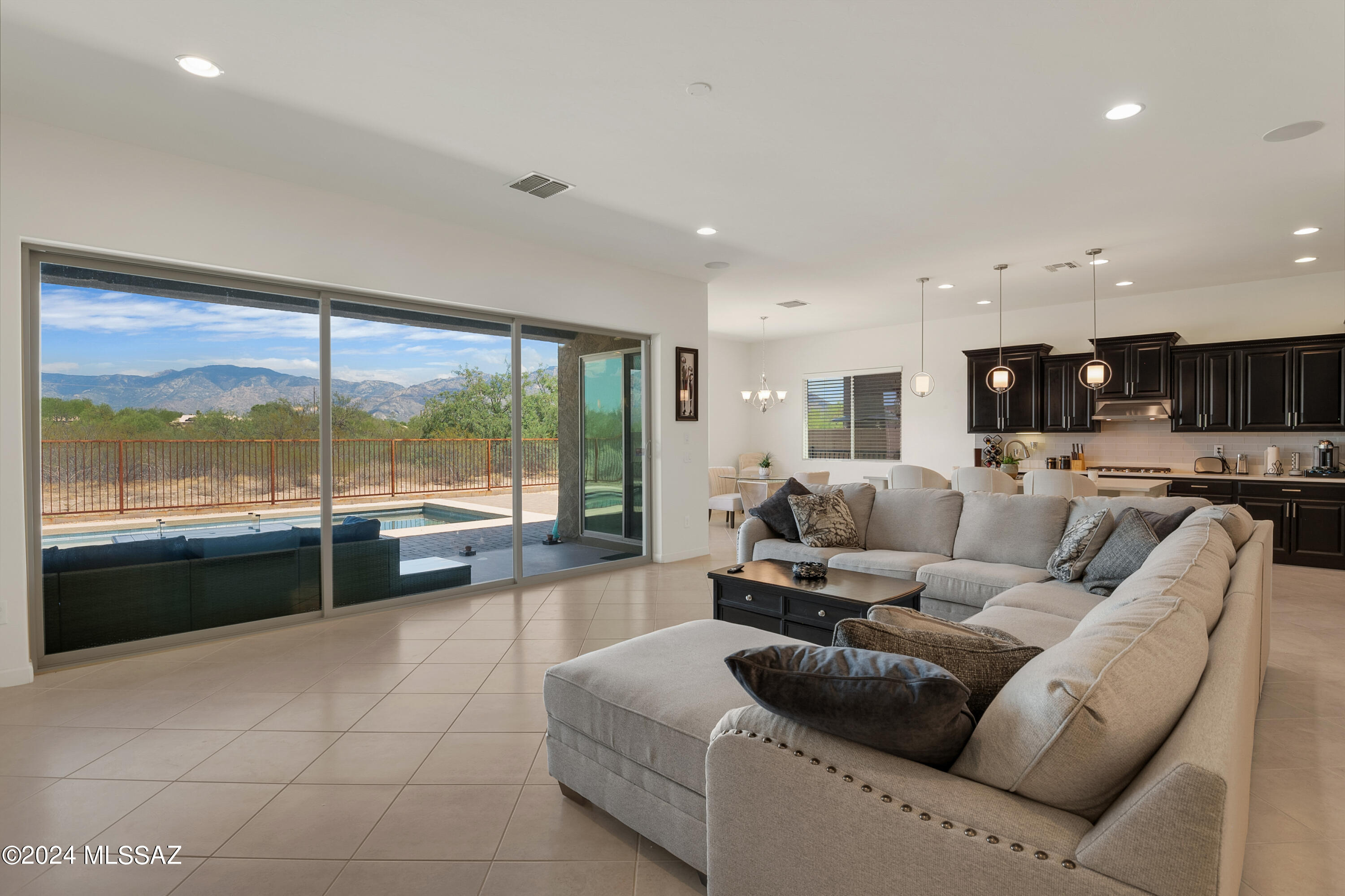 Open house Saturday 08/17/24 from 10am-1 pm. and Sunday the 18th 1-3 pm. Call agent for gate code. Fabulous mountain views from East facing rear yard. Beautiful Meritage Home in gated Estates At Capella. 4 bedroom, 2.5 bathroom, split floor plan with bonus room. Open kitchen to great room. Kitchen boasts stainless steel appliances, four burner gas cook top, 42'' upper raised panel cabinets with crown molding, Quartz counter tops, huge island with bar seating, ''pocket office'', plus huge walk-in pantry. High ceilings, neutral ceramic tile throughout except bedrooms. 3 car tandem garage. Laundry room, separate mud room. Easy care rear yard with pool and fabulous views. Large dining room, plus breakfast nook. Sliding glass door from breakfast nook and sliding glass wall from great room.