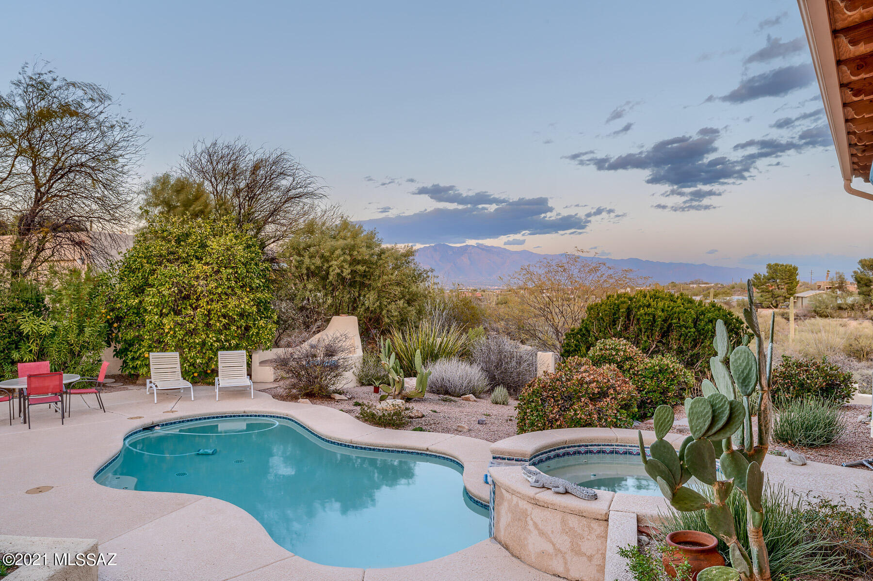 Drive up to a circular driveway of pavers, enter thru large double doors, and be transported into the epitome of southwestern lifestyle! The Stunning Catalina and city views and backyard oasis have been brought into the home thru a wall of windows, extending the entire length of the house. This backyard with its sparkling pool/spa, lush vegetation, outdoor kitchen, expansive covered patio areas, and even a meditation area complete with a fireplace/seating, is perfect for entertaining! This 3244 sqft/4 bdrm/3 ba/3 car, split bdrm plan home boasts travertine flooring and viga beams throughout. The kitchen features granite counters and stainless appliances. This property on 1.88 acres affords privacy/tranquility while viewing wildlife. Make this enchanting home your own!