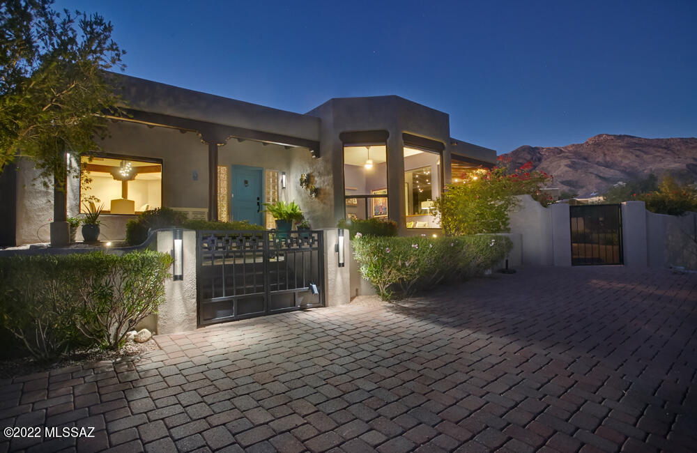 View, views & more views! Nestled high on a hill this home welcomes you to sit back & relax. This elegant updated custom Santa Fe is an entertainer's delight! From sunrise to sunset you will love the Catalina, Rincon mountain & city lights on the wrap around patio. All main living areas have large windows w/the cozy fireplace is perfect for cool nights, pool/spa perfect for hot summer nights. Chef's kitchen updated in 2018, opens to a spacious great rm. w/beamed ceilings, gas fp. The formal living/dining! There isn't a bad seat in the house! This 4 br 3 ba home plus office has been updated and meticulously maintained. The outdoor space has lush vegetation. Primary br/ba have been fabulously updated. Don't miss the list of features under documents. Work completed since 2017.