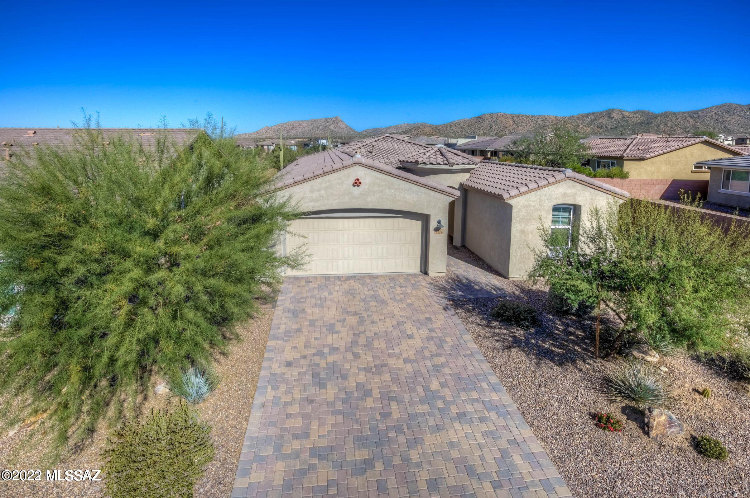 Welcome to this gorgeous, MOVE-IN READY home in the beautiful Blue Agave community at Dove Mtn.  This popular Sycamore Floor Plan features 2,113 sq.ft., 2 Beds PLUS a large Den w/French Doors, 2.5 Baths and a bright, open Great Room! The kitchen is an entertainer's dream, featuring quartz ctops, custom backsplash, undercab lighting, SS appliances, a huge kitchen island, walk-in pantry & custom pendant lighting!  The split floor plan creates privacy, with a half bath for guests.  The Primary Bedroom boasts of a luxurious en suite bathroom with an expansive quartz vanity, spacious walk-in shower and generous closet!  Incorporate your outdoor living with the wall of windows in the Great Room, double sliding doors, covered patio and mountain views! Best of all, no waiting on new construction!