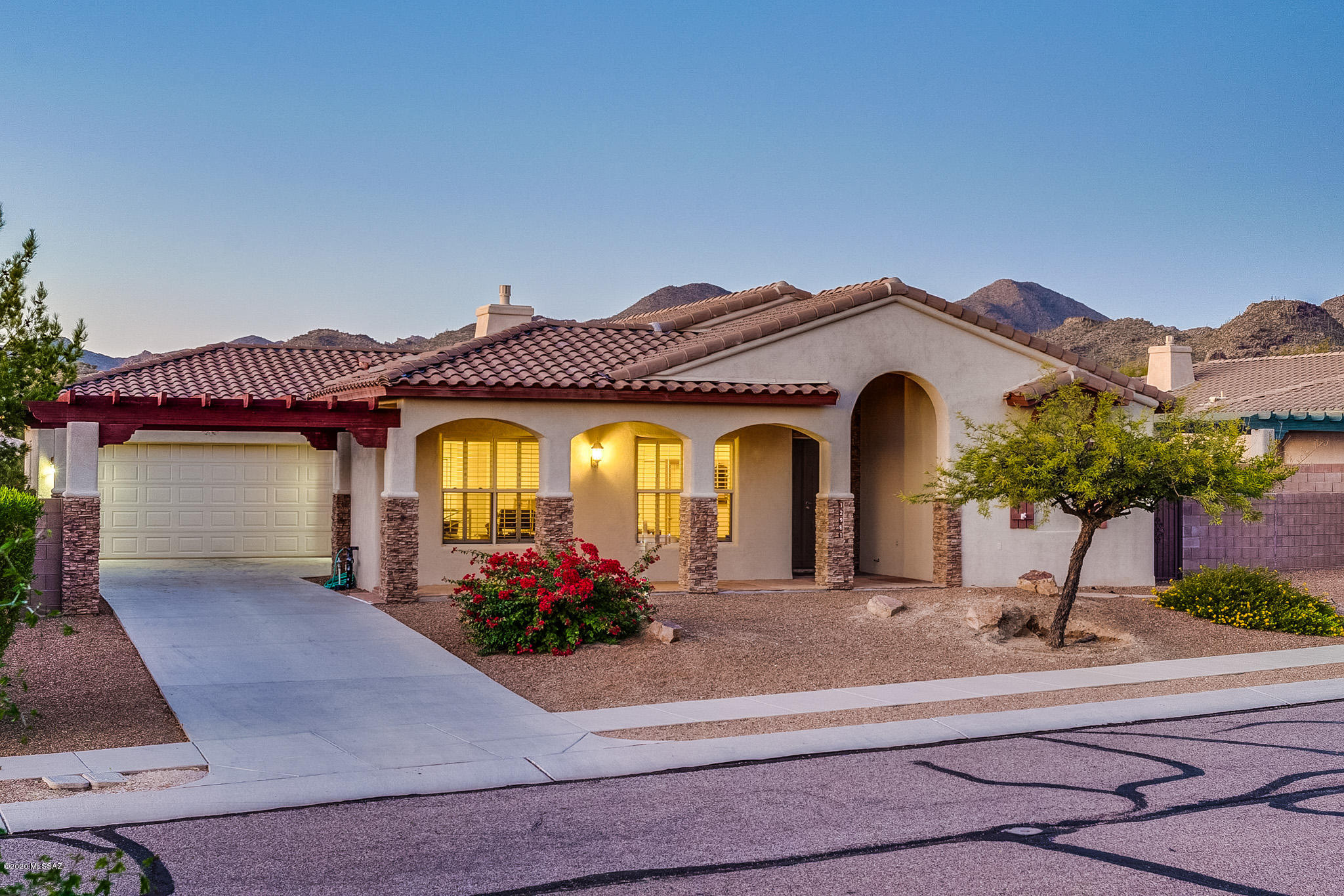 Don't miss this high-end built In The Bluffs at Dove Mountain! This gorgeous home boasts 3 bedrooms and 2 bathrooms that sit in a well appointed split floor plan with 2,131 square feet. Open family room with cozy fireplace and tasteful built-in shelving. Kitchen has granite counter tops, stainless steel appliances and breakfast nook. Spacious owner's suite with cherry wood floors, has his/hers vanities in bathroom plus soaker tub with separate shower and walk-in closet. Entertainer's dream backyard has built-in BBQ, extended patio with concrete block pavers and backs to green belt with spectacular mountain and sunset views. The community of Dove Mountain is perfectly tucked away just outside of the hustle and bustle but still close to shopping, schools and entertainment! Welcome Home