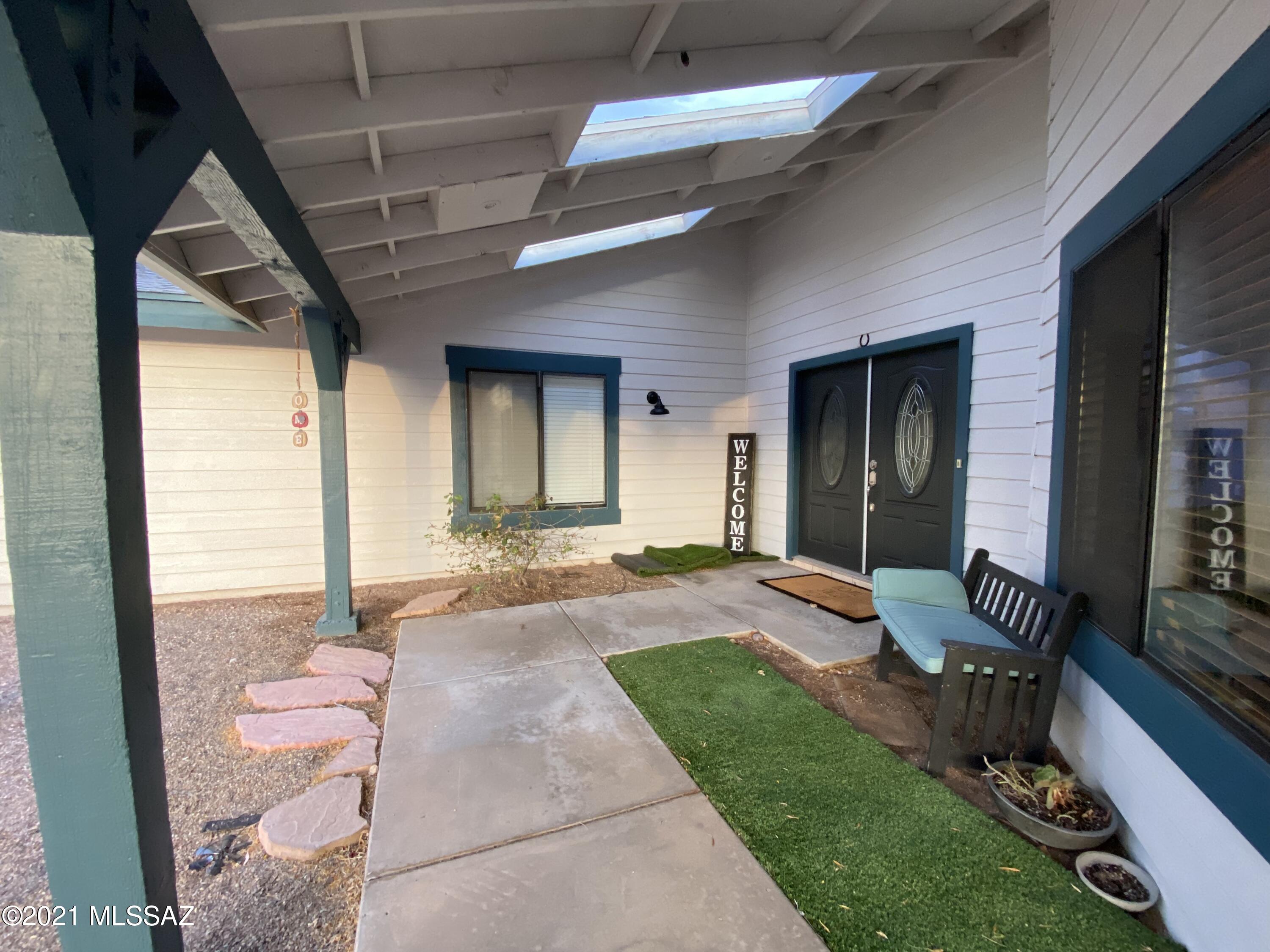 This is it a 7 bedroom single story home with a 2 bedroom single story guest house in the Tanque Verde School District. The main house features two master suites, vaulted ceiling throughout, wood looking tile throughout, new ceiling fans & wood laminate in rooms. Split floor plan- 5 bd on one side & 2bd on opposite side (gym & office) The kitchen boasts an abundance of cabinets, island w/ gas cook top, plus 2 breakfast bars for plenty of seating. Walk outside to a large walled yard, w/ covered patio & turf grass plus sparkling pool & spa. The separate (unattached) guest house features full kitchen & dining room w/ views to the Catalina mountains 2 bd/1ba plus interior laundry area, covered front patio, separate entrance & separate walled backyard. North/South orientation all located on over an acre on beautiful Windridge Loop.  This home is perfect for multi-generational living, care home, Air BNB or just some spread out peace & quiet! All bedrooms have closets but the simple floorplans makes for easy changes if you prefer to make 2 bedrooms into 1 large room. The possibilities are endless- Library, Gym, man cave/woman cave, Office, art studio, etc. Plenty of parking, over sized garage & extra storage shed.