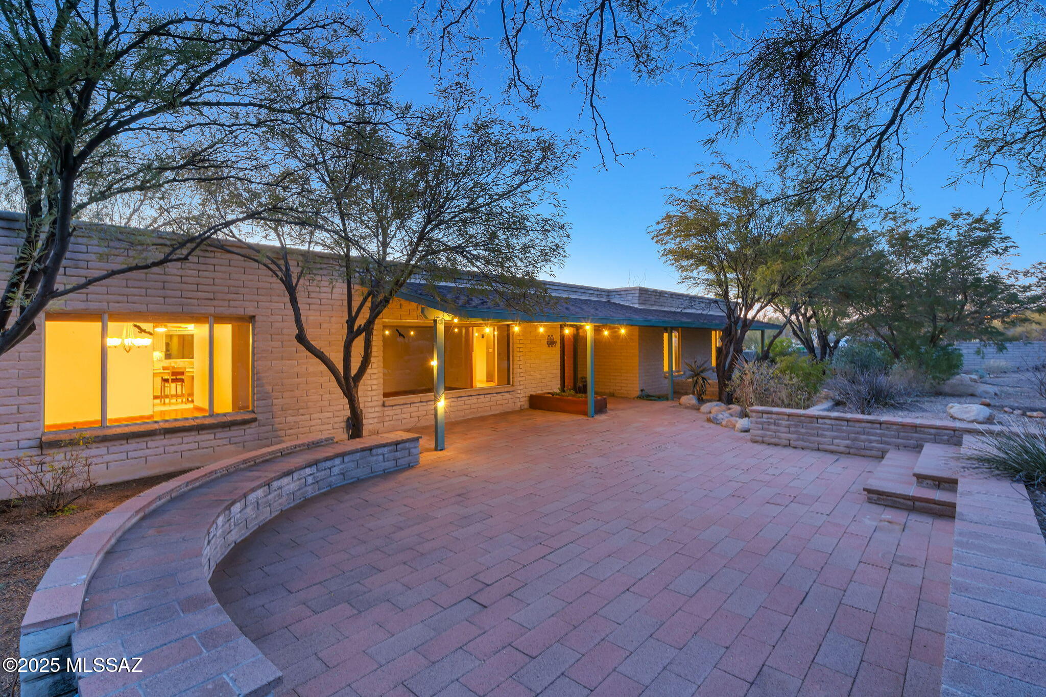 It's not just a house, it's an oasis and your day begins with the morning light illuminating the mountain view from your beautiful front courtyard with artifacts personally selected by you from  local artisans. Now it's mid day and time for a sauna break and lunch by the pool. Guests are coming, so you prepare a buffet in your gourmet kitchen and serve it in the formal dining room. Your guests are enjoying their meal while lounging in the living room, great room, and out by the pool. The evening is capped off with guests watching an ouutdoor movie while floating in the pool with their favorite beverage, or joining you in the hot tub, and the sauna! This all begins with you telling your agent you want this house before the people who just saw it get it first!