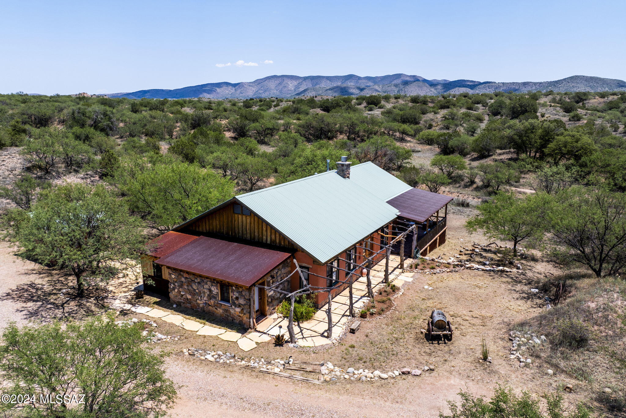 WOW!  Remarkable sustainable  custom home  on 20  tree-studded acres just outside the quaint, historic Town of Patagonia.  Small residential community on 8 acre lots or larger, with no HOA.  Built by an engineer and his artist wife of autoclaved aerated concrete (AAC) block finished with mud adobe plaster and stucco.  Interior adobe bricks were made on the property, and the oak lintels harvested from its trees.  2Bd/2Ba with flex space/family room, rock-walled dining room and wrap-around porch with sleeping area. Antique Mexican interior doors and custom woodwork.  Steam shower, mini-splits, radiant floor heating and special Rumford fireplace all provide all year comfort.  Separate storage & workshop and  plenty of room for a Casita, garage or barn. See attached list of custom features.