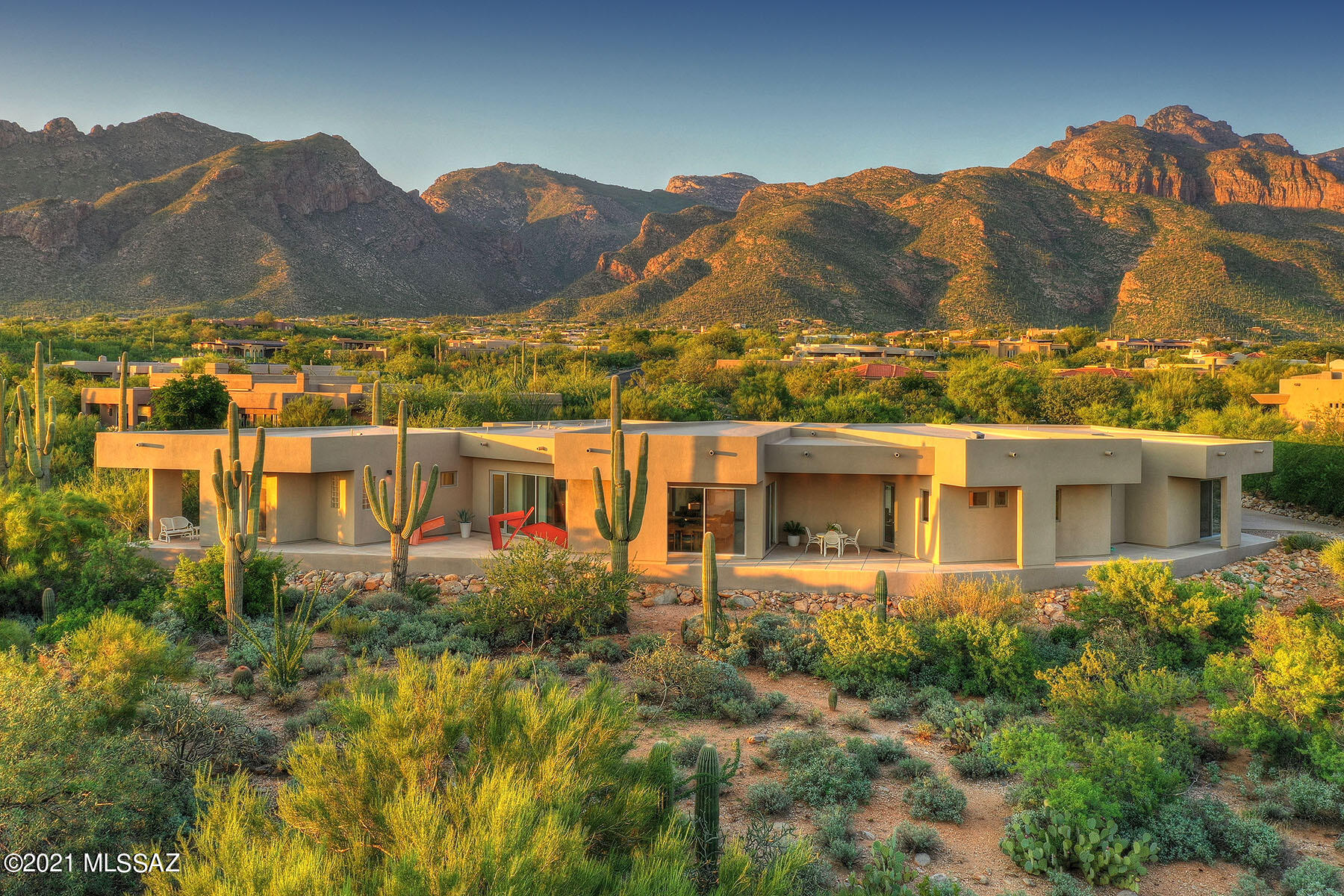 Exquisitely designed Contemporary home in coveted Pima Canyon is perfectly sited to capture the beauty of the Catalina Mountains, natural desert and city lights.  The 4200+ sq. ft. house was built around a center courtyard w/lap pool and features an abundant use of glass doors providing natural light and views from every room. The kitchen w/large center island & contemporary cabinetry opens to the family room, breakfast area and lovely South facing patio.  The great room w/spacious dining area and built-in entertainment center is the perfect space to relax.   Two guest rooms have ensuite baths and private patios.  A uniquely styled office or 4th BR has 2 window walls offering stunning views while you work.  The oversized 3-car garage has tons of storage and epoxy floors.  A must see!