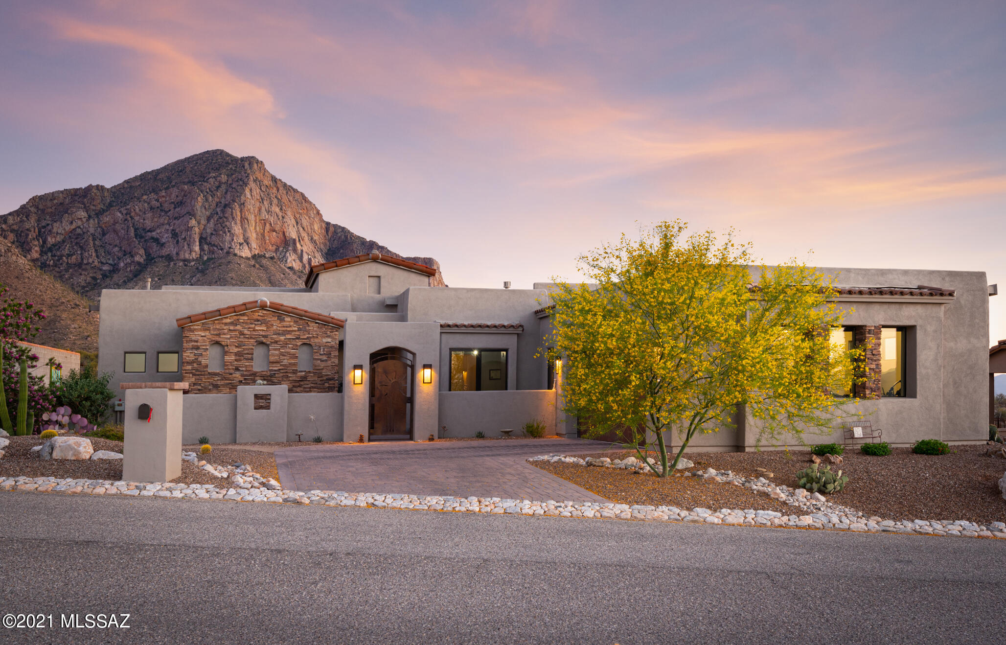 SPECTACULAR VIEWS all around this stunning home in the Guard Gated Ponticello neighborhood within La Reserve. Enjoy views of twinkling town lights, the Tucson Mountains, the Tortolita Mountains & the Dramatic Pusch Ridge. The Catalina Mountains are so close, it feels like you can reach out & touch them. With dramatic ceilings & 9' tall glass windows you can enjoy the magnificent sunsets or the pink reflection on mountains in the evening from inside your home. Wake up to beautiful mountain sunrises from your private suite that offers dual vanities, a spacious shower and a nice walk-in closet. Spacious Great Room w 12' ceiling includes a gas fireplace and auto blinds on the large back windows to keep the house cool. Two back doors have custom metal screen for plenty of fresh air to match the The two back doors have custom metal screens for plenty of fresh air and match the custom metal front entry gate. Home boasts 8' alder doors and on-lay concrete floors throughout. IMAGINE MAKING YOUR MEMORIES IN THIS STUNNING ONE-OF-A-KIND SETTING. 

Fountain in Backyard does not Convey.