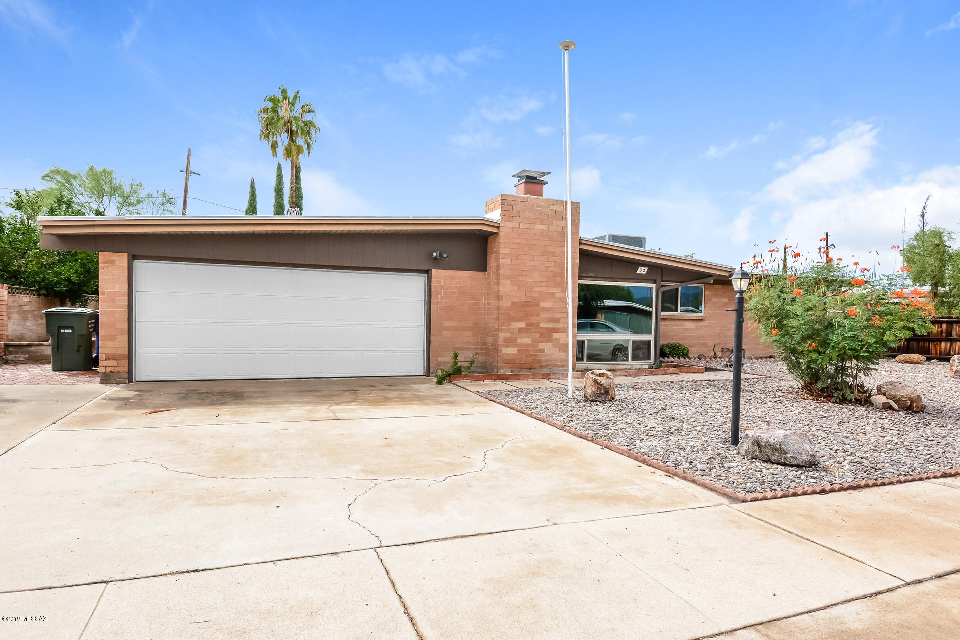 This Tucson one-story offers an in-ground pool, a fireplace, granite kitchen countertops, and a two-car garage.