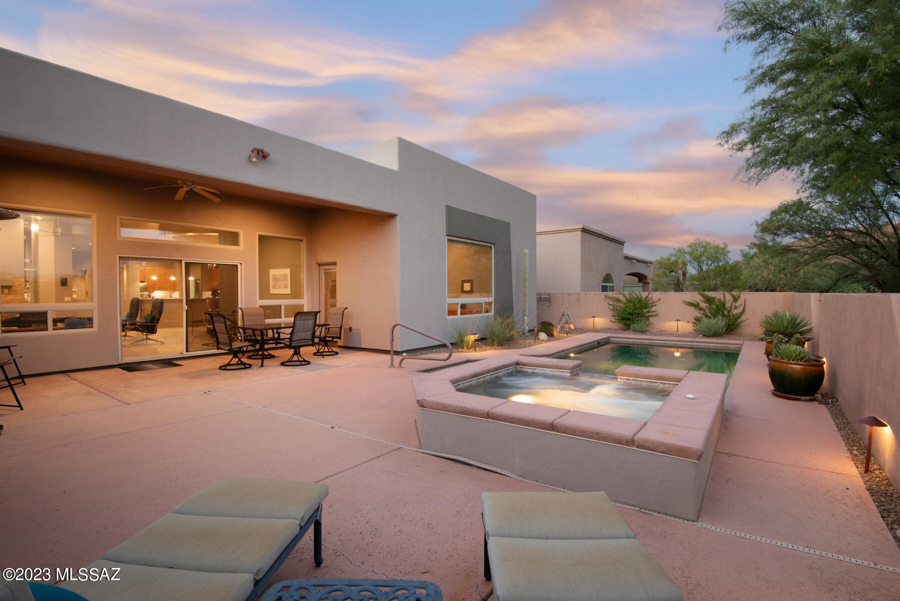 Impeccable 2006 foothills home situated on a quarter-acre lot in a gated enclave of contemporary homes just minutes from Sabino Canyon.  Designed by renowned architect Marc Soloway, this exceptional residence is a harmonious fusion of modern design & effortless function. Owned solar panels provide maximum efficiency. Upon entry, the elevated ceilings & open floor plan create an immediate sense of spaciousness without excess. The thoughtfully designed split bedroom floor plan delivers seamless privacy offering a private retreat within each corner of the home. Interior features include skylights, ceiling fans, ceramic tile & wood floors(no carpet in this home.) Upgraded kitchen w/ stainless steel appliances, granite counters, ample cabinets & counter space. CONT... The open kitchen w/ breakfast bar for informal dining connects to the dining area, & the great room, divided by a dual-sided fireplace, serves as a captivating centerpiece that provides warmth and character and a natural division while creating flexible space for a den, office, or reading room. Generous-sized owner's suite w/ wood floors, a gas fireplace, a big walk-in closet w/ custom built-ins, & a spacious & bright bathroom w/ large dual sink vanity & a huge tiled shower. Oversized laundry room loaded w/ storage cabinets and a sink. Beyond the interiors, the outdoor living spaces offer seamless indoor/outdoor living. Sliding glass doors from the great room lead to a covered patio & a low-care backyard w/ a solar-heated pebble-tec pool & spa & a built-in BBQ.  Oversized 3-car garage w/ storage racks & plenty of room for cars & more. Live in a peaceful & private location with proximity to everything! Whole Foods, Starbucks, Sabino Canyon, Ventana Canyon Resort & Country Club, Udall Park, The Loop, great restaurants & shopping.