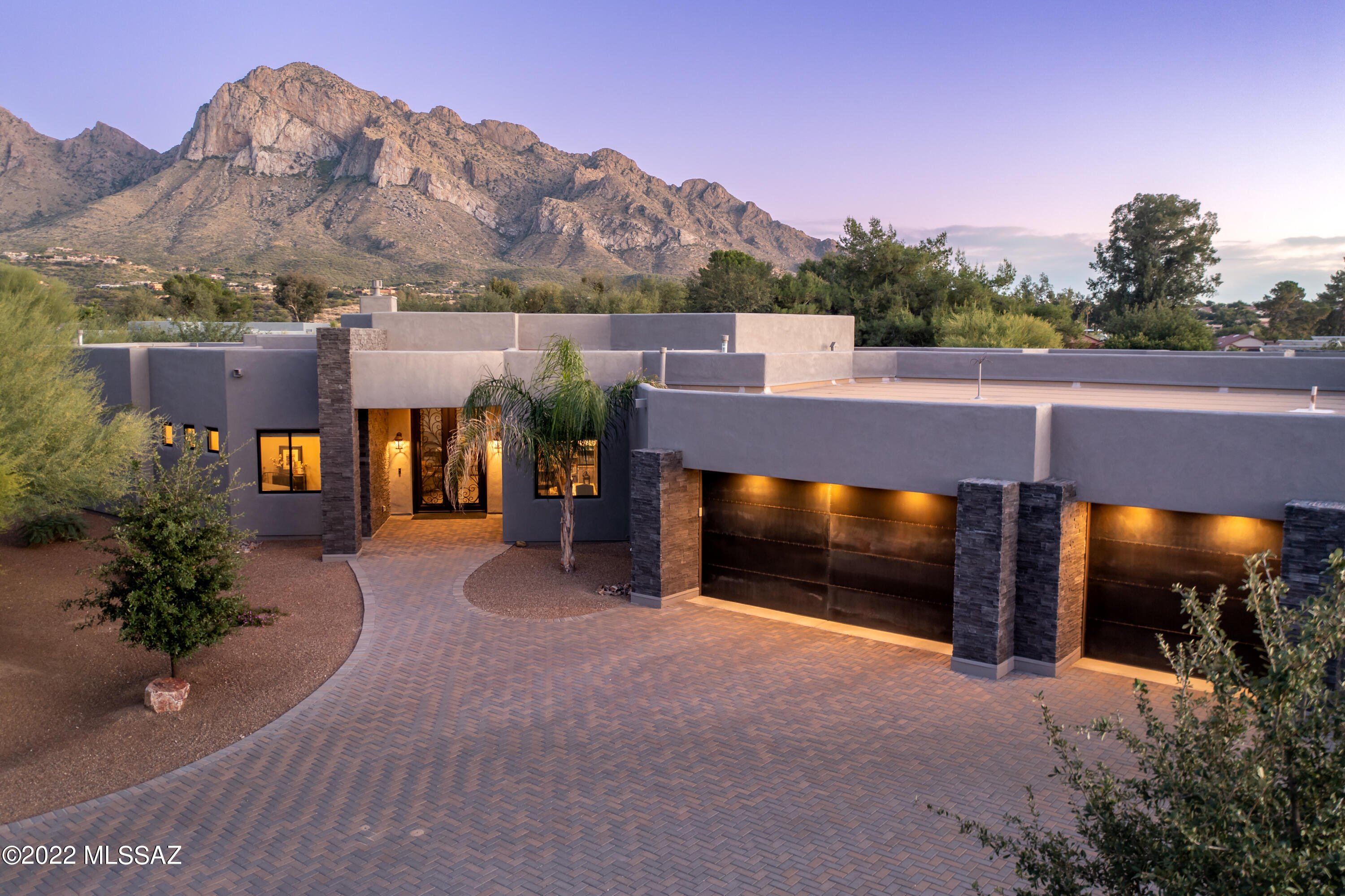 Gorgeous luxury home in the historic Oro Valley Country Club on 1.47 acre lot! Built by Copper Canyon Homes, one of Oro valley's premier custom homebuilders, this 3830 square foot home borders the golf course and also offers stunning Catalina Mountain views. With its split bedroom floorplan, everyone is afforded privacy—family members or guests. The palette and design is easily adaptable to a contemporary or traditional feel depending on your furnishings and artwork. Beautiful, realistic, wood-look 6 x 24 porcelain tile runs throughout the home. Other designer selected finishes include the knotty Alder interior doors, Pottery Barn lighting, window coverings and Maple Onyx cabinetry throughout the home.  
The open living space features a floor to ceiling wall of windows showcasing mounta views, tray ceiling with beams and commanding stacked stone fireplace with rough-edge slate capped hearth. The chef's kitchen boasts a walk-in pantry, an abundance of cabinetry with wood dove-tailed soft-close drawers, granite counters, deep farmhouse sink, island with prep/veggie sink, 5 burner gas range, custom backsplash and more. Adjacent to the kitchen is a sun-filled breakfast nook. Dining is a delight in the formal dining with on-trend boho-chic chandelier and tray ceiling. Guests have the use of a gorgeous bath with backlit mirror, to the ceiling subway backsplash and dramatic walk-in custom tiled shower. 
The primary suite overlooks the rear outdoor spaces and opens onto the patio area with mountain views. The primary ensuite bath offers dual granite topped vanities, a soaking tub with garden windows and an oversized walk-in shower. Pottery Barn crystal chandeliers highlight the bedroom and massive walk-in closet and lend a boutique feel. 
The other wing of the home offers two guest suites with their own baths and a media room/flex space with custom barn doors. This wing also houses the well-equipped laundry room with cabinets, counters and sink a well as the spacious extended length three car garage. 
Outdoors, the generous covered patio area has dining and lounge spaceperfect for taking in those breathtaking Catalina views. The huge lot with plenty of space to add a pool currently has a walled in area with faux grass and basketball court. Utilize the extra space beyond the fence to create additional outdoor features or leave it in its natural stateits up to you! 
Perched along the banks of the Canada del Oro near the base of Pusch Ridge, this exclusive golf course community that preceded the Town of Oro Valley is not only historically relevant, it is one of the most wildly beautiful and coveted communities in the area. Featuring a gorgeous private golf course resplendent with mature trees and lush Bentgrass greens, this gorgeous community offers rolling streets with jaw-dropping views. Thoughtfully oriented large lots allow residents to be as social or as private as the prefer. The private golf course offers full and social membershipsbut there are no requirements to join to be a resident here.
With an excellent location and easy access to Oracle Road as well as the popular 131-mile multi-use "Loop", getting around is a breeze. Your new home is located mere moments to the soon to be reimagined and rebranded Oro Valley Village Center (complete with shopping, dining, and movie theaters), the Oro Valley Library, Catalina State Park, Town Hall, The Oro Valley Farmers Market at Steam Pump Village, and an array of different shopping and dining options.