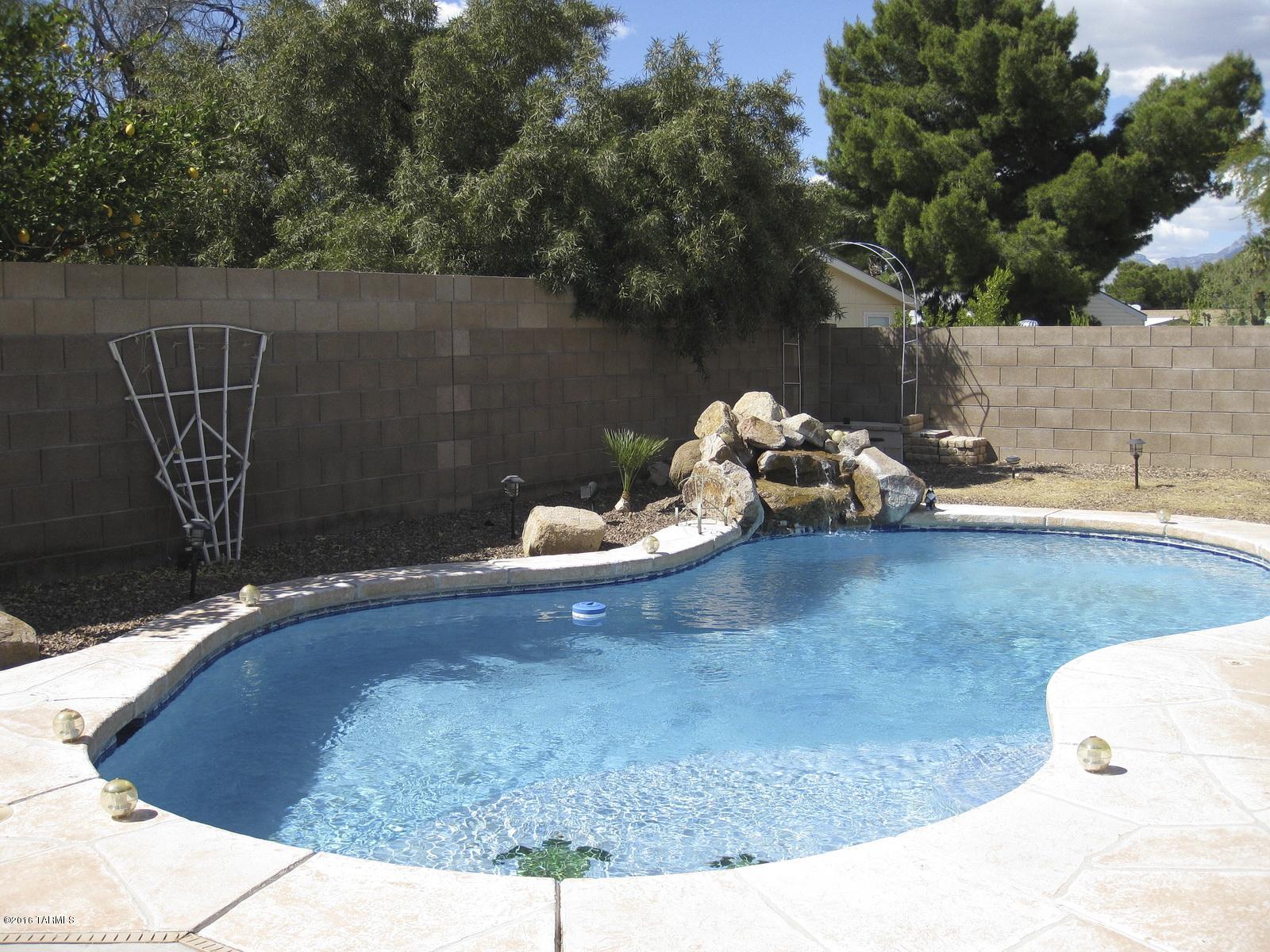 MOVE-IN READY SINGLE-STORY HOME WITH POOL & MOUNTAIN VIEWS! This 3 Bedroom, 2 bathroom property features a lovely Open Kitchen with newer stainless steel appliances that opens into the Family Room and separate Living Room and Dining Area. Vaulted Ceilings throughout, tile and carpet flooring, ceiling fans, laundry room, and Two-Car Garage. Large Master Suite with roomy walk-in-closet, Garden Tub, and Separate Shower. The Huge Well-Maintained Backyard features Gorgeous Catalina Mountain Views and has a covered patio and an inviting Pool with a Waterfall. Double-gate side yard entry opens onto an extensive cement slab that can be used as a basketball court. All curtains not convey with sale