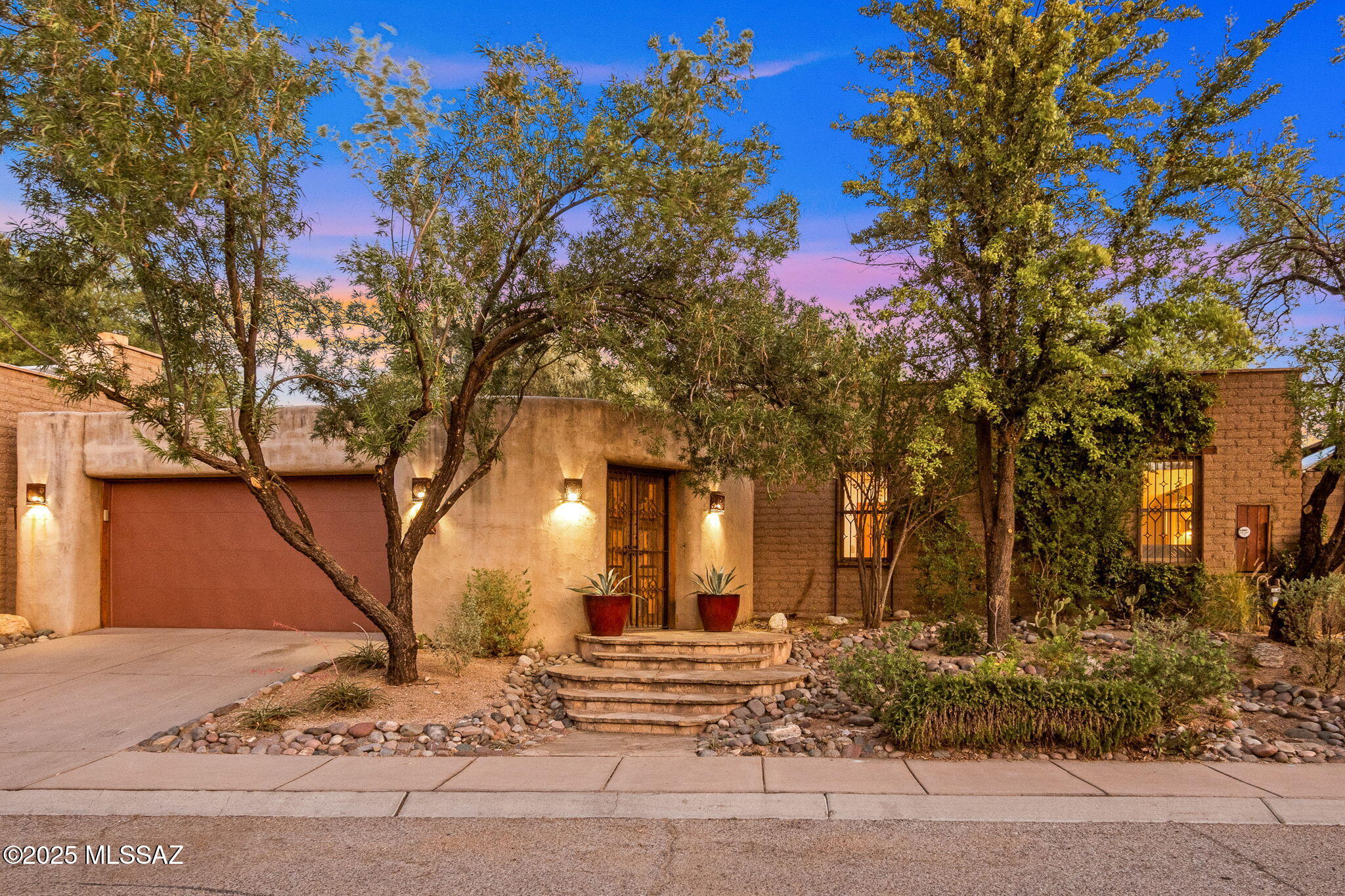 Nestled in one of Tucson's most sought-after midtown neighborhoods, this exceptional mud adobe residence is a timeless fusion of historic craftsmanship and architectural artistry. The home exudes Southwestern elegance, with graceful archways, thick rounded walls, and an earthy color palette that blends seamlessly into the Sonoran landscape. A private central courtyard, inspired by traditional hacienda design, offers a tranquil outdoor retreat perfect for both relaxing and entertaining. Inside, original scored concrete floors, wooden lintels showcasing traditional craftmanship. High ceilings with exposed wood beams adding warmth and authenticity and rustic sophistication. Expansive windows, two interior adobe fireplaces, and an impressive French front door fill the home (more).. with natural light and create a harmonious indoor-outdoor connection.
The generous primary suite features French doors opening to both the front courtyard and the backyard, enhancing the home's fluid, open feel. Out back, the spacious yard is finished with flagstone flooring, a covered patio, an adobe fireplace, and a built-in BBQ grill ideal for gatherings under the desert sky.
Located in a vibrant midtown community celebrated for its historic charm, this home is more than just a place to live t's a work of art that captures the soul of the Southwest.