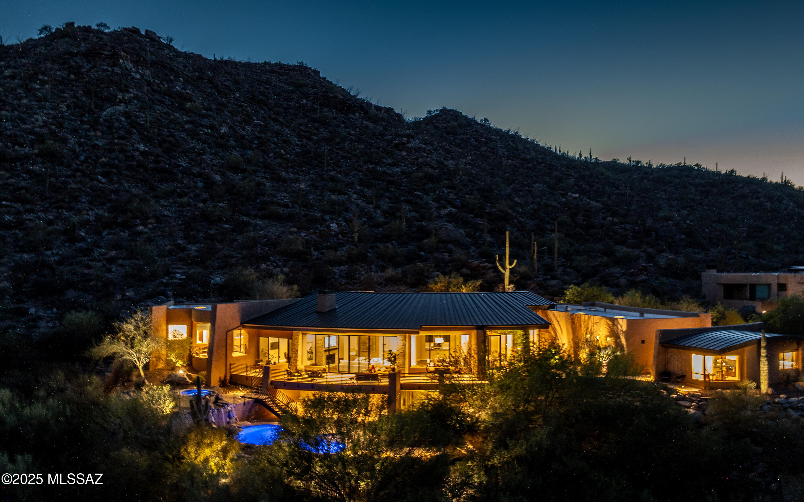 Experience a higher level of luxury w/bold style and engaging design. Meticulously crafted this custom residence promises to redefine your concept of luxury living, offering an exquisite blend of comfort, luxury and engaging design.  Floor to ceiling views . Nestled in the heart of the Tortolita Mountains - Canyon Pass at Dove Mountain brings sophistication and elegance to the heart of the Sonoran Desert.  Over 5000sf main house + a comfortable, private guest house w/separate bedroom, mini kitchen & dining/lounging area. Grand open great room concept home. Flowing indoor-outdoor living. Multiple patios, decks and exterior gathering areas, pool, spa, outdoor kitchen & BBQ areas - + mesmerizing mountain & city light views. The Epitome of Luxury Living Welcomes You. Call for private showing. Please read Highlight/Upgrade/Remodel sheet in MLS Documents to view the plethora of remodeling that has been done to this home. Fabulous value for this luxury guard gated community home.