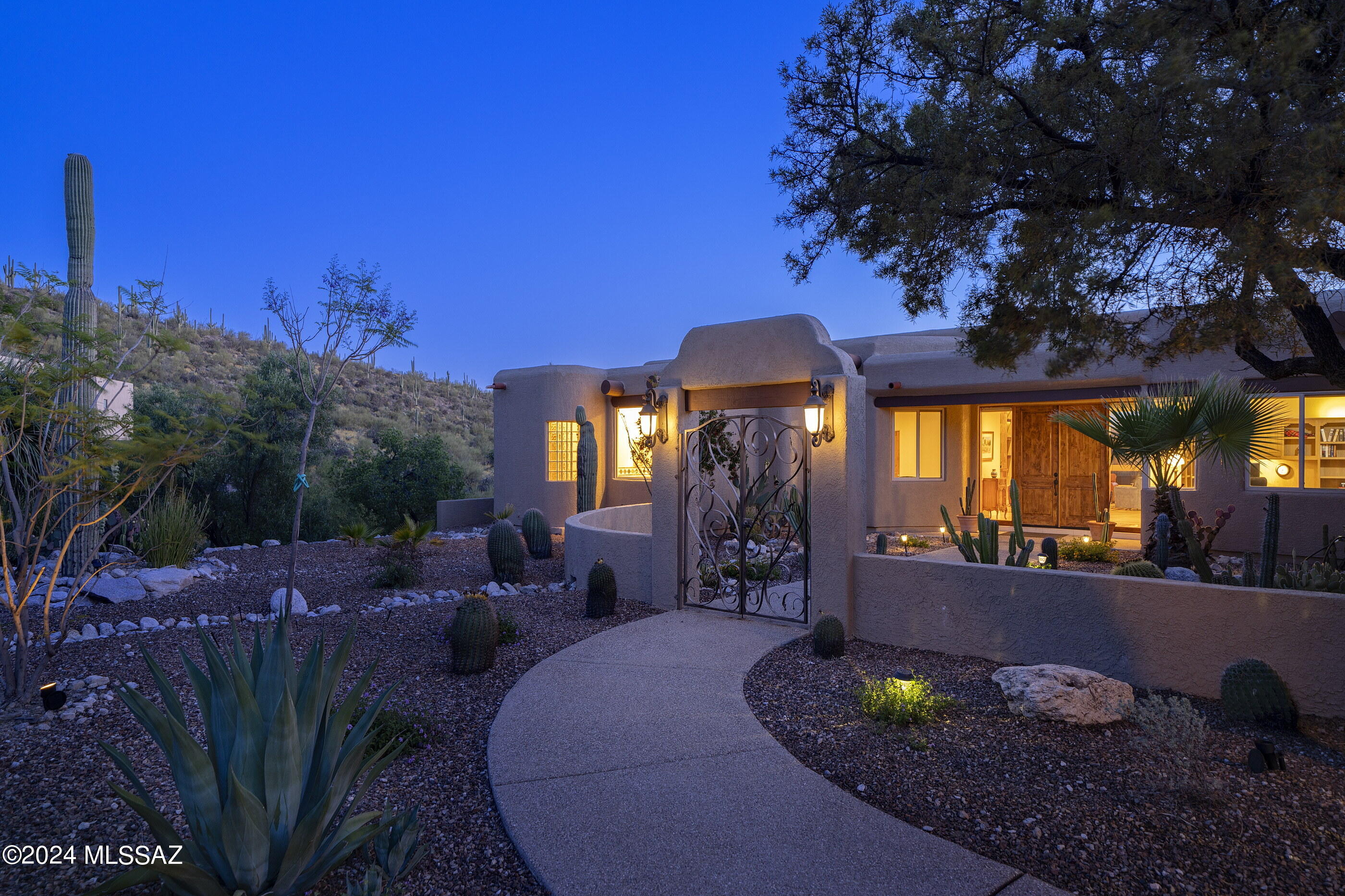 Sweeping views of the mountains and city lights from this stunning Alta Vista retreat perched high on a corner lot. Walls of windows bring natural light and picturesque sunset views into this spacious retreat. Features included beautiful travertine floors, split floor plan, high ceilings. Chef's kitchen is the heart of the home w granite island, custom cabinetry, SubZero fridge, Thermador gas cooktop, Dacor double ovens,eat at bar which opens to the spacious family room w/corner fireplace. Wonderful living room and dining area w stunning travertine accent to fire place, also  featuring a full bar w seating, perfect space for entertaining. Enjoy gorgeous sunsets & unobstructed city views from the patio & sparkling pool and spa.  Spend evenings around the outdoor cozy fireplace. The grand primary suite features fireplace, the spacious primary bath includes a jetted tub, separate shower, dual vanity, and oversized walk-in closet. 4 Spacious bedrooms w/2 set up as of offices  featuring custom built ins and a Murphy bed complete this gracious home.  Don't miss the 6 car garage, 3 bays, 2 deep with storage room and more. Seller owned solar panels for the home installed. Solar shades installed on west side of home.