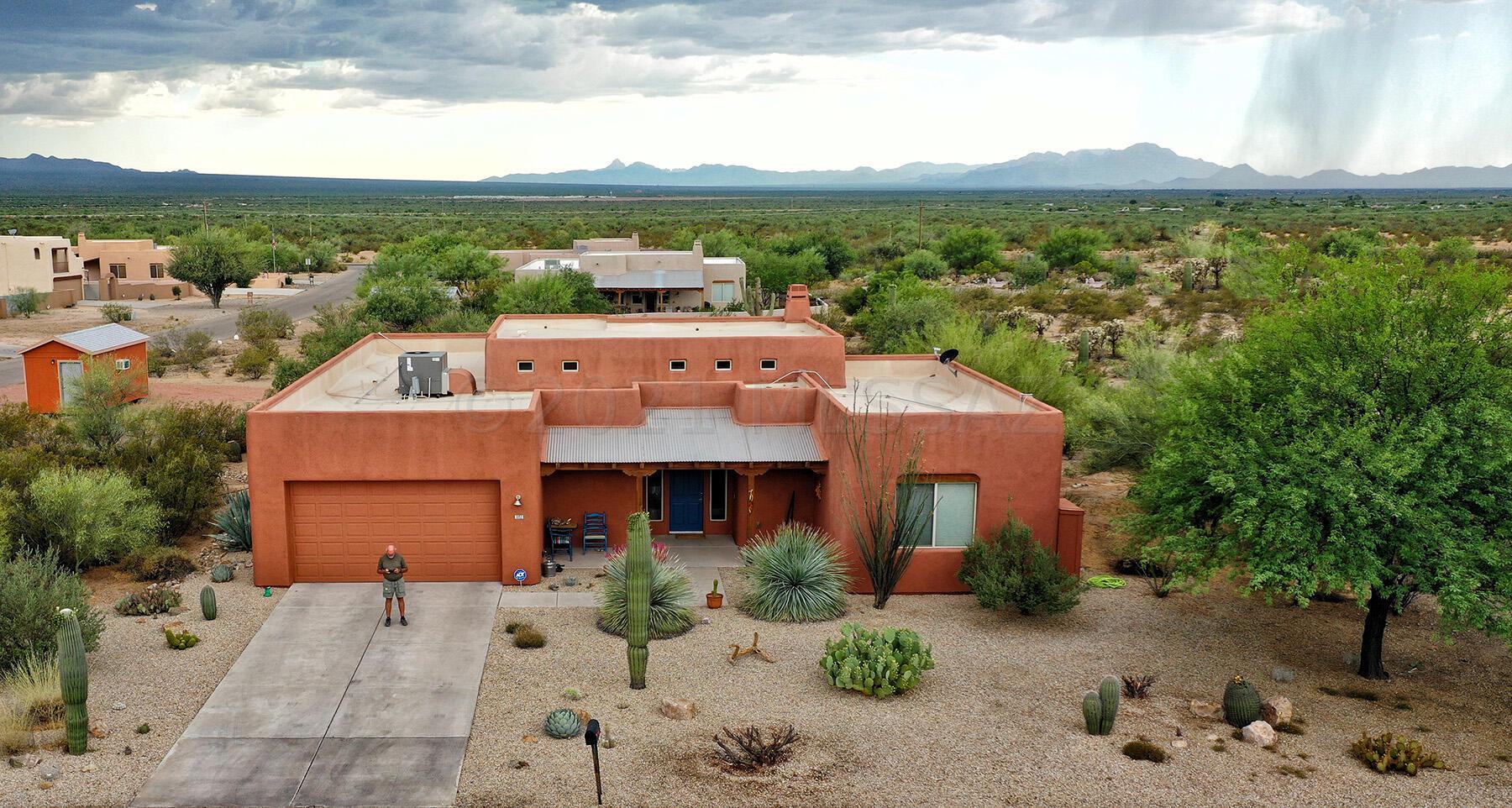 This remarkable home is situated on a HUGE lot and is loaded with upgrades! Beginning with the pleasing curb appeal, low maintenance landscaping and surrounded by the beautiful Arizona Desert. Once inside you'll love the tile flooring throughout the home, high ceilings, unique wood column accents, and open floor plan. The kitchen is spacious and features ample storage and wonderful sight lines to the living room and dining room. Great for entertaining! The workshop/studio has been added and is cooled/heated for full comfort while working! Upgrades include whole home water softener system, rooftop heat pump replaced in 2018, New water heater in 2020, Reverse Osmosis System in the kitchen and more! Don't miss the chance to see this amazing home today!