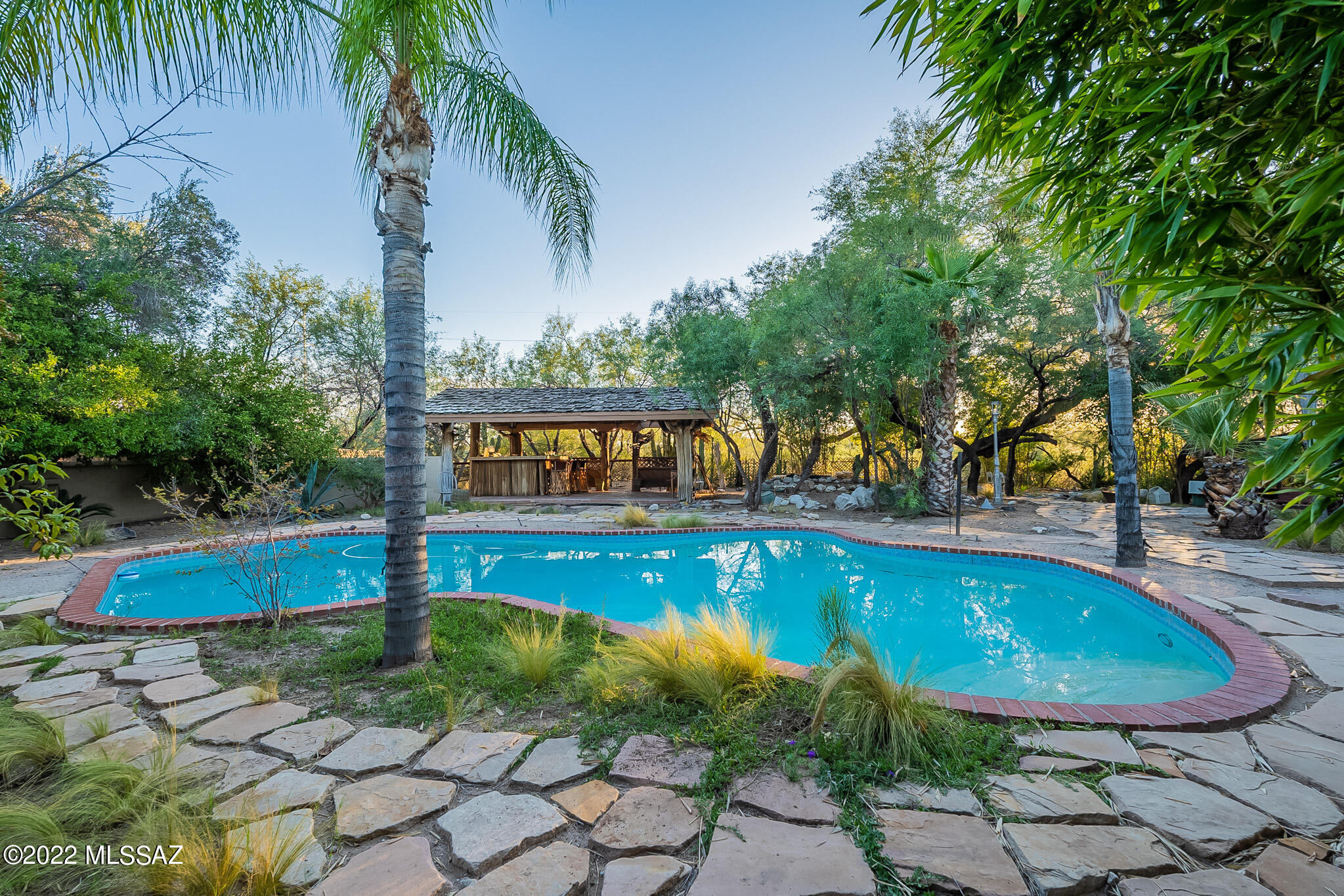 Charming Tucson Country Club home. Extensive grounds include a sparkling pool, and lush landscape. This 3bd 3bath southwestern style home is situated on a .73 acre horse property. Great for entertainment. the home also includes a palapa which overlooks the Pantano wash. Cabana that oversees pool has a sink, plumbing, and refrigerator ready to be reimagined! Don't miss this opportunity to live in one of the great neighborhoods in Tucson! Priced to sell!