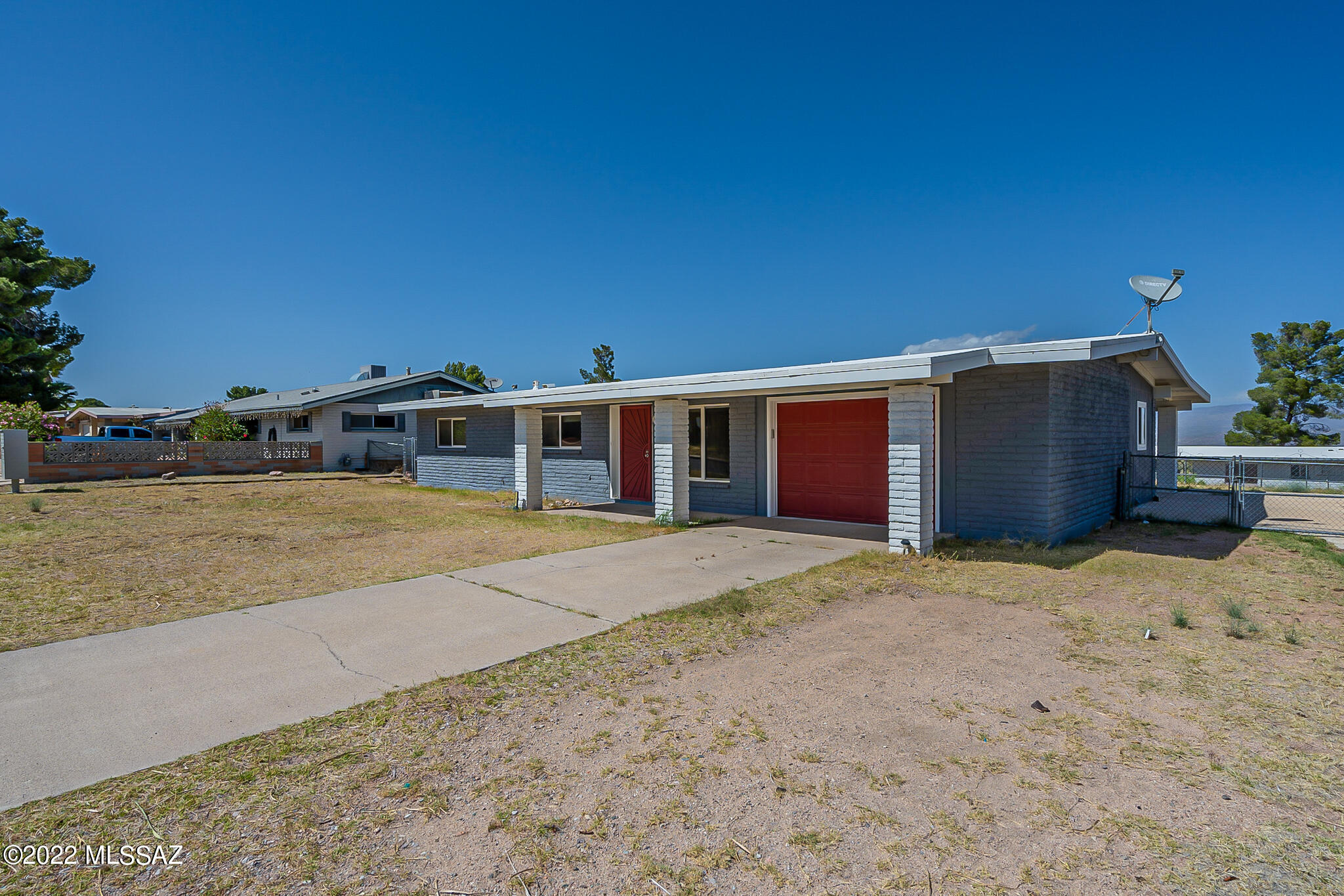 This home has a beautiful updated kitchen with quartz countertops, a tile backsplash and gas stove.  There's large tile flooring throughout.  The primary bedroom is large with a walk-in closet.  The primary bathroom has a tile shower, granite countertops and double sinks and full size bathtub.  A one car garage that features laundry and additional storage.  The HVAC and water heater are approximately one year old.  The roof is newly coated.  The home has RV hookup and back alley access.  Rear yard is fenced.