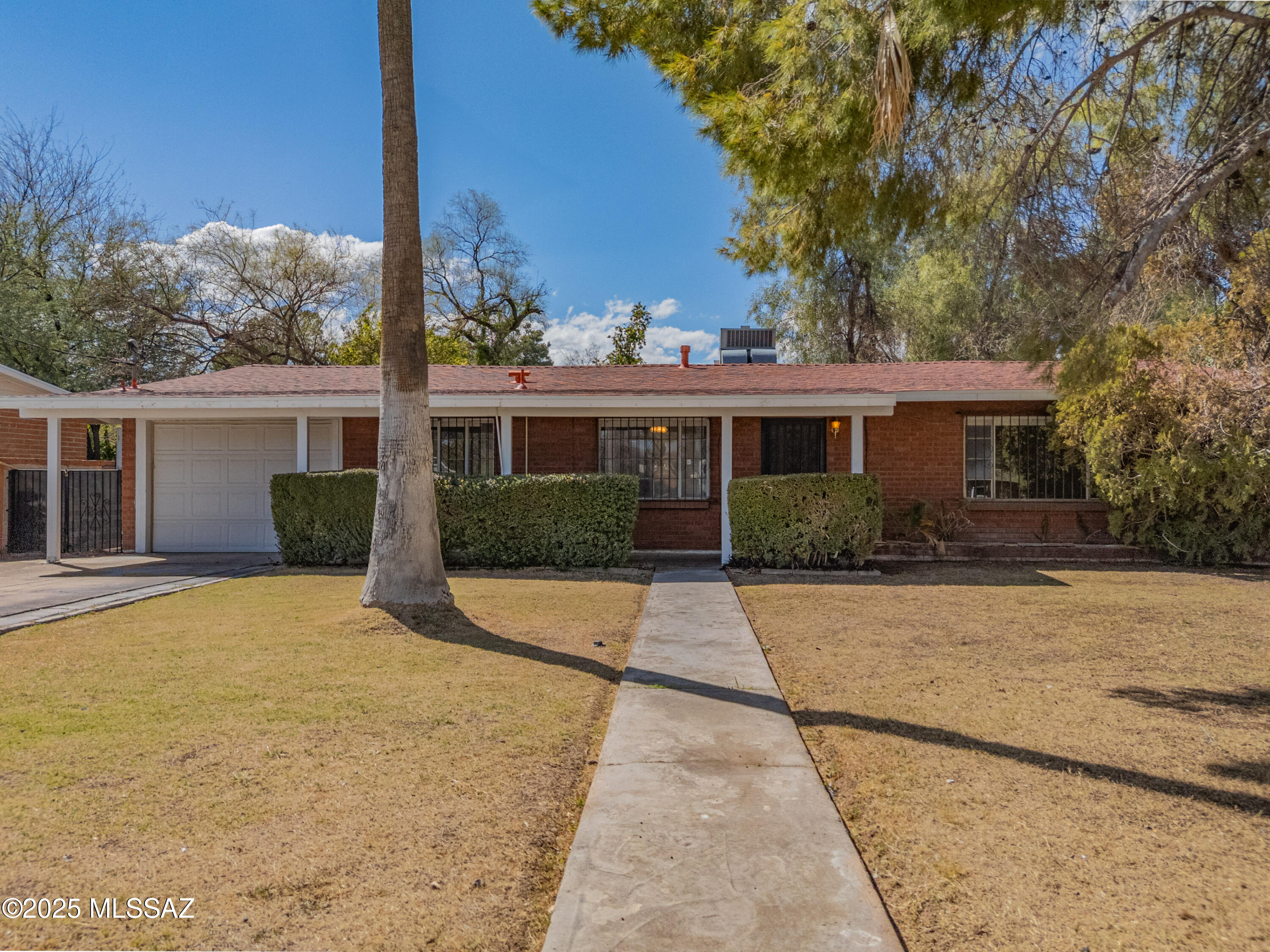 Welcome Home to this Sweet and Solid 3 Bed 2 Bath Brick Charmer in the highly sought-after neighborhood of Winterhaven!  Nestled among Mature Trees on a Spacious Lot  with a Huge Backyard this home is full of Charm and Character.  It has a Welcoming Layout with a Well-Appointed Kitchen featuring Stainless Steel appliances, Double Oven and Sub-Zero Refrigerator, perfect for entertaining.  Primary and Hall Baths complete with original 1950s tile to add to the Classic Charm.  2nd Bedroom has been converted into a Dressing Room complete with a Cedar Closet.  3rd Bedroom has Oak Desk and Murphy Bed perfect for Office/Guest Room.  HOA pays water and provides Security Service.  Here's your chance to become part of Tucson's beloved Winterhaven!