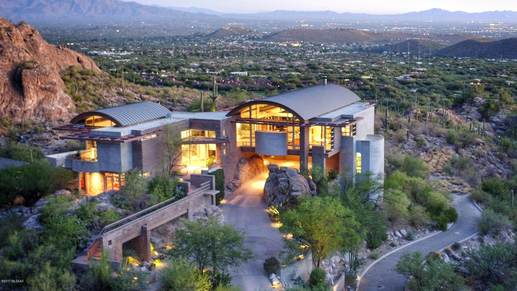 DRAMATIC PURE CONTEMPORARY W/TOP OF THE WORLD VIEWS IN PRESTIGIOUS GATED VENTANA CANYON MT. ESTATES.  DESIGNED BY ARCHITECT DON KORNBERG, A GLASS AND STEEL MASTERPIECE, EXQUISITE GREATROOM W/ HIGH CEILINGS, FIREPLACE, DINING AREA, GOURMET ISLAND KITCHEN WGRANITE AND STAINLESS STEEL APPLIANCES, LOVELY BREAKFAST AREA, COZY TV ROOM W/BOOKCASES, POLISHED CONCRETE FLOORS, ELEVATOR FROM GARAGE TO KITCHEN, 3 BEDROOMS, 3 1/2 BATHS INCLUDING MASTER WITH LUXURIOUS SLATE AND GRANITE BATH, WALK IN CLOSET, PRIVATE PATIO. ENJOY THE SERENE SETTING W/ COVERED PATIO, BROOK-LIKE WATER FEATURE AND POND, SPA, BBQ, LUSH VEGETATION AND VIEWS, VIEWS, VIEWS. FLOOR PLAN AND DRONE VIDEO LOCATED UNDER PHOTOS, VIRTUAL TOUR.