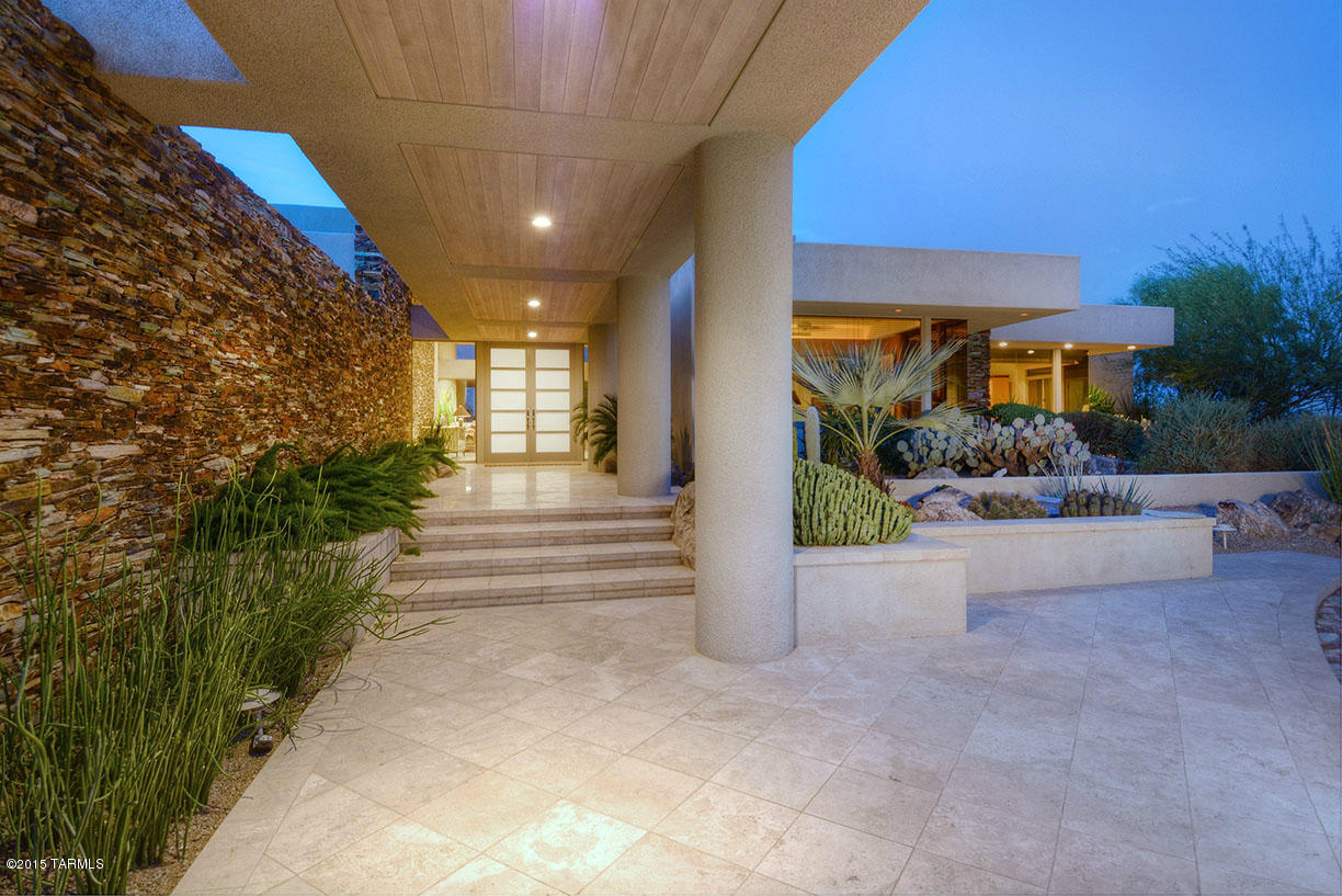 Fabulous California Contemporary custom home sitting on a very private lot high up in Finisterra with views of city lights and Catalina Mountains. Casual sophisticated elegance best describes this stunning home with clean lines. Only the best in finishes and materials used, ceiling to floor windows in most rooms, stacked stone entry wall, SieMatic kitchen, second master or huge guest suite, den and 3rd bedroom currently being used as office. Deep covered patio with true negative edge pool and spa.