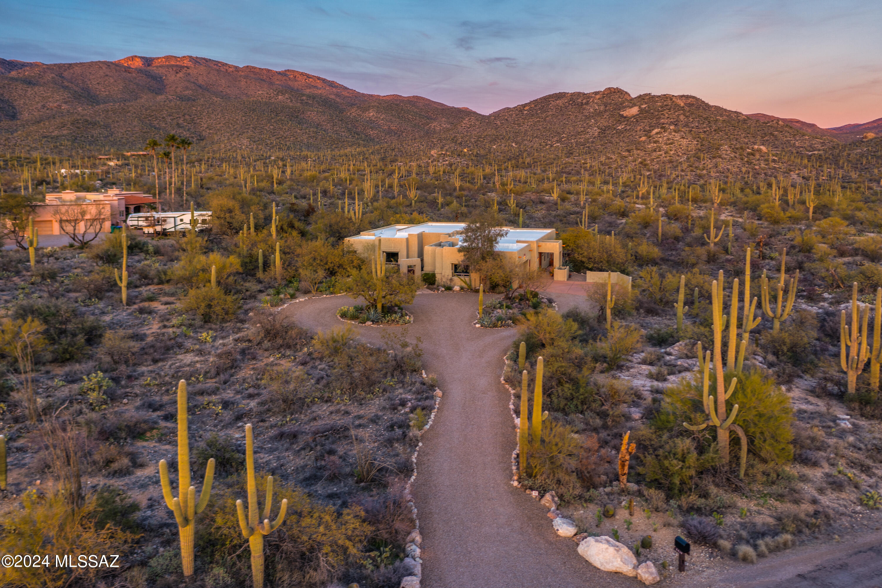 Welcome Home ! Built by 7 Time Home Builder of the year, Pepper Viner Homes. Meticulously maintained. First time on the market. A gated Courtyard with soothing fountain welcomes you to this 3.924 Square Foot floor plan with 4 Bedrooms, 4 Bathrooms, Formal dining & living room , family room + a library/office with a built in Cherry desk & book shelves. Nestled in the Tanque Verde Valley where the Rincon & Catalina Mountains connect. Breathtaking views from every window, a luxury estate & a natural desert habitat. Resort like backyard with a built in BBQ. with seating. Alfresco dining on the covered patio. 3 Fireplaces, spacious laundry room with plenty of storage, oversized garage with a workshop. Kitchen has Cherry Cabinets. Primary bedroom entry doors were  imported from Spain.