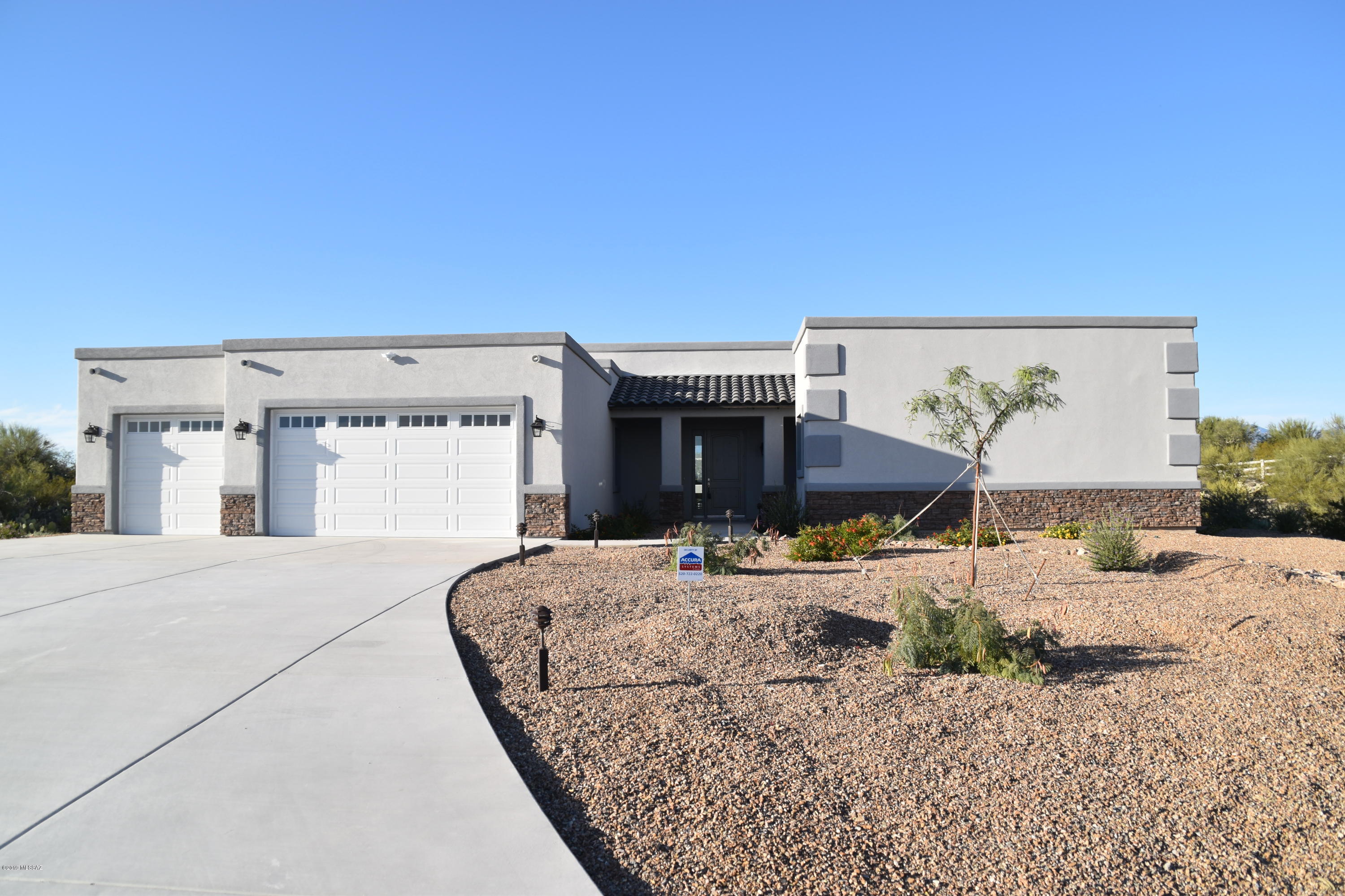 New Custom Home by Buddy Greer Homes located in the cozy gated community of Manning Camp Enclave.  This fully fenced property is 3.6 acres at the base of Saguaro National Monument East with panoramic views of all mountain ranges.  Enjoy the sunrise and sunsets each day.  This contemporary open floor plan is perfect for entertaining.  Gourmet kitchen with granite countertops; Granite Counters in bathrooms with custom tile work.  Bonus room perfect for office or library.  Lots of extra storage in laundry room.  Expansive covered back porch limited only by your imagination. Owner related to agent.