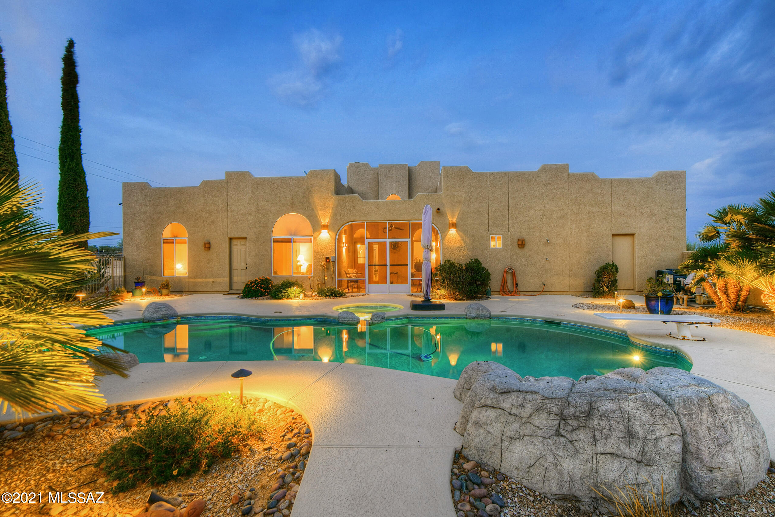 Seller to entertain/counter offers between $850k-$890k. Privacy and views! Situated on a generous 3.3 acres in NW Tucson, this fully functional, horse-friendly property is primed for the equestrian lifestyle or expanding your homestead to include gardening, hobbies, and more. Fully fenced property with auto entry gate, arena, 12x24 workshop with garage door, and 6-stall horse barn with tack room, electricity and water. A circular drive offers convenient guest parking, with plenty of additional open space to accommodate trailers, storage, or recreational toys. Outdoor 360-degree observation deck offers sweeping mountain and desert views during the day and spectacular sunsets, twinkling lights, or stargazing at night. Welcoming Santa-Fe inspired home features generous living spaces, Welcoming Santa-Fe inspired home features generous living spaces, grand arched doorways and windows, and a striking cupola ceiling with clerestory windows flooding the main entry room with natural light. Comfortable, inviting kitchen with gorgeous granite-topped counters, ample storage/workspace, and adjacent dining area and nook with cozy fireplace is perfect for quality family time. Deluxe owner's suite with elegantly remodeled bath features an extended granite-topped vanity, tile surround walk-in shower, and jetted tub. Three additional bedrooms plus a bonus attached apartment with full kitchen, living area, bedroom, and full bath is perfect for multi-generational living, guest quarters, or income potential. Serene backyard retreat with diving pool, spa, and enclosed covered patio is perfect for relaxing or casual outdoor entertaining!