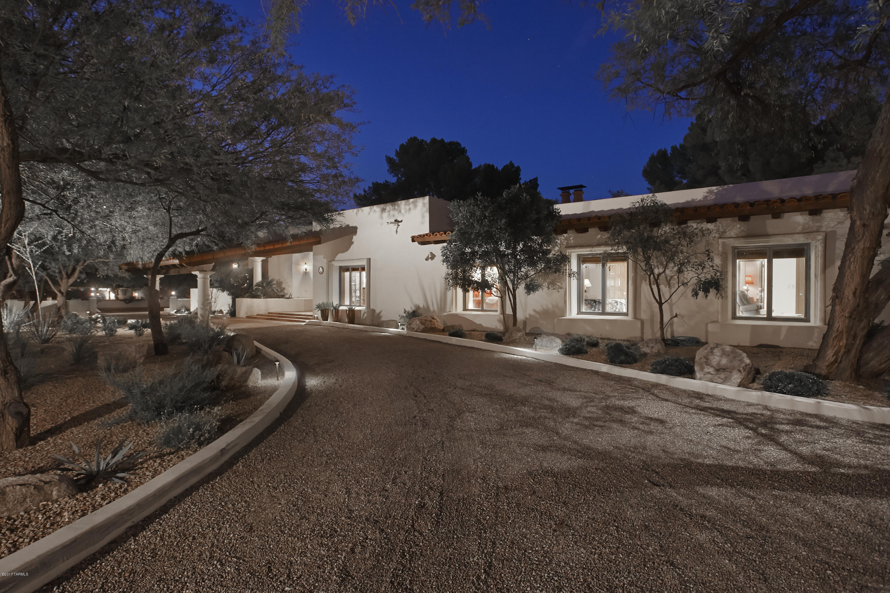 Featured in Tucson Lifestyle, this enchanting Spanish Hacienda epitomizes the Tucson C.C. Lifestyle. Designed around the Zaguan entry, this 5BR hm features high corbeled ceilings & timeless craftsmanship. A stunning liv.rm opens onto an inviting patio w/firepl. The cozy library w/firepl opens onto the mstr bdrm suite that has a luxurious bath & elaborate built-ins/closets. The formal dining rm, butlers pantry & wine cellar are ideal for entertaining. The heart of the home is the great rm/kitchen w/Viking & Sub Zero appliances, hand painted tiles & stainless island. French doors open onto a deep porch & glorious patio shaded by mesquite trees & lush plantings; an idyllic area for entertaining. A study in authentic Spanish Colonial & Hacienda design make this one of T.C.C.’s finest homes.