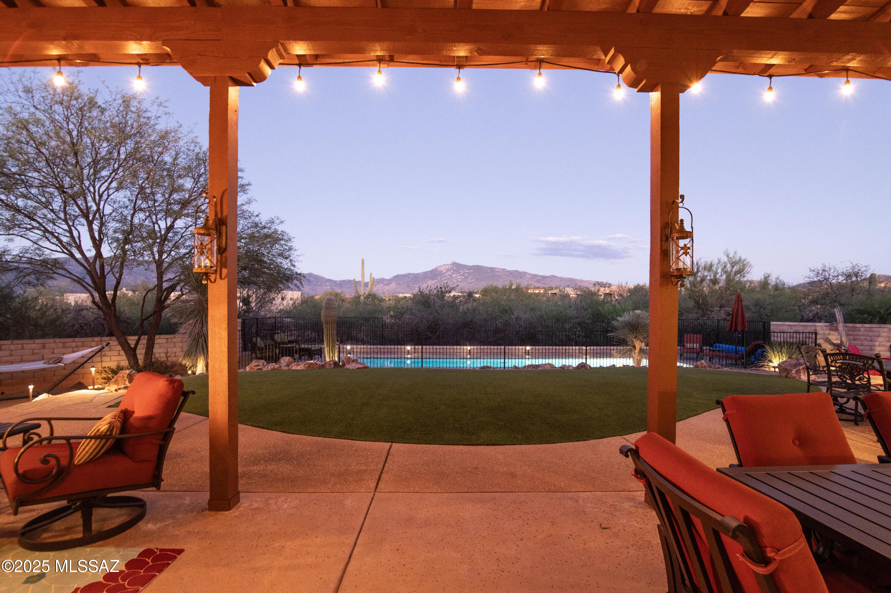 Arizona Living at Its BEST...Luxury and style come together in this beautifully crafted custom home located in the picturesque, gated community of Coyote Creek. Be prepared to be impressed by a lavish 4-bedroom, 3-bath split floor plan plus a versatile office space. Recently modernized with new exterior paint, this home is as turnkey as it is stunning. The great room welcomes you with soaring wood ceilings, a cozy fireplace, and picture windows that perfectly frame the spectacular mountain views. The heart of the home is the newly updated gourmet kitchen, featuring custom cabinetry, stainless steel appliances, tasteful backsplash, granite countertops, and a built-in pantry. When it's time to unwind, the spacious primary suite offers a spa-inspired bath with soaking tub, custom shower, and generous walk-in closet. Outside you'll discover the true showpiece: a brand-new heated lap pool that sparkles against the mountain backdrop, creating a resort-style experience year-round. Whether swimming for fitness, lounging under the sun, or enjoying the glow of a Tucson sunset, this pool elevates outdoor living to its finest. Surrounding it, the backyard retreat offers an expansive porch, hot tub, multiple seating nooks, built-in BBQ, artificial turf, mature landscaping, and even a fire pit area for smores .... all designed for both entertainment and relaxation. Additional highlights include two new mini splits in the garage, New HVAC systems, and custom garage doors. Then the oversized 3 PLUS car garage (closer to 4) with epoxy flooring provides ample room for vehicles, toys, and storage. This spectacular property, combined with thoughtful updates and exceptional amenities, makes this a must-see Home. Experience Arizona living at its absolute best.