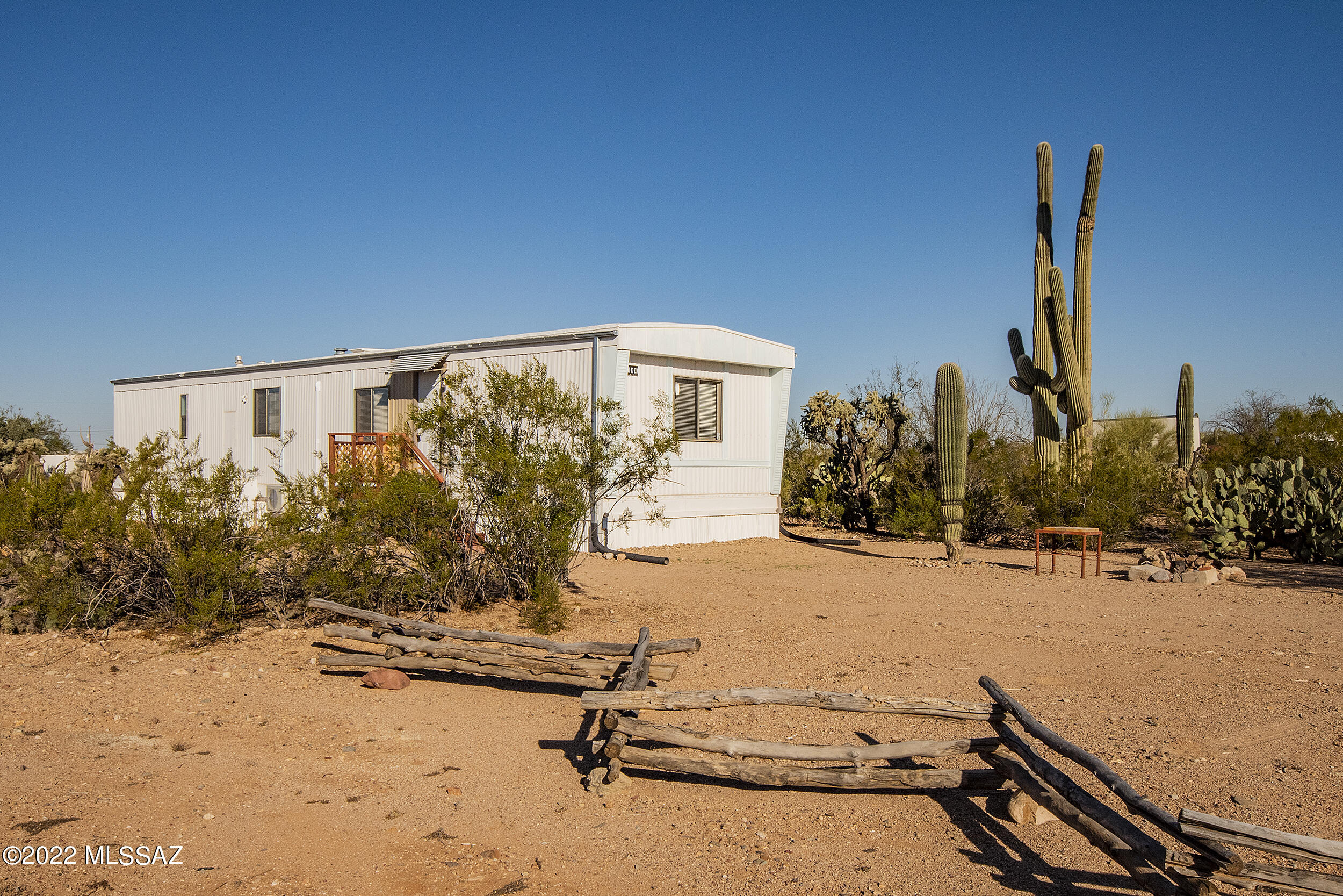 This is a great manufactured home that sits on a beautiful 1 acre lot with Mountain views. This is a move in condition with a great room that opens onto the kitchen. This has a split bedroom floor plan perfect for having guest. There is also a 2 car detached carport and storage. This property has water from a water company in the area. the lot is heavily vegetated with Saguaros. The home comes with a complete set of appliances. his home sits back off the road to give you privacy. You will enjoy looking at this home.
