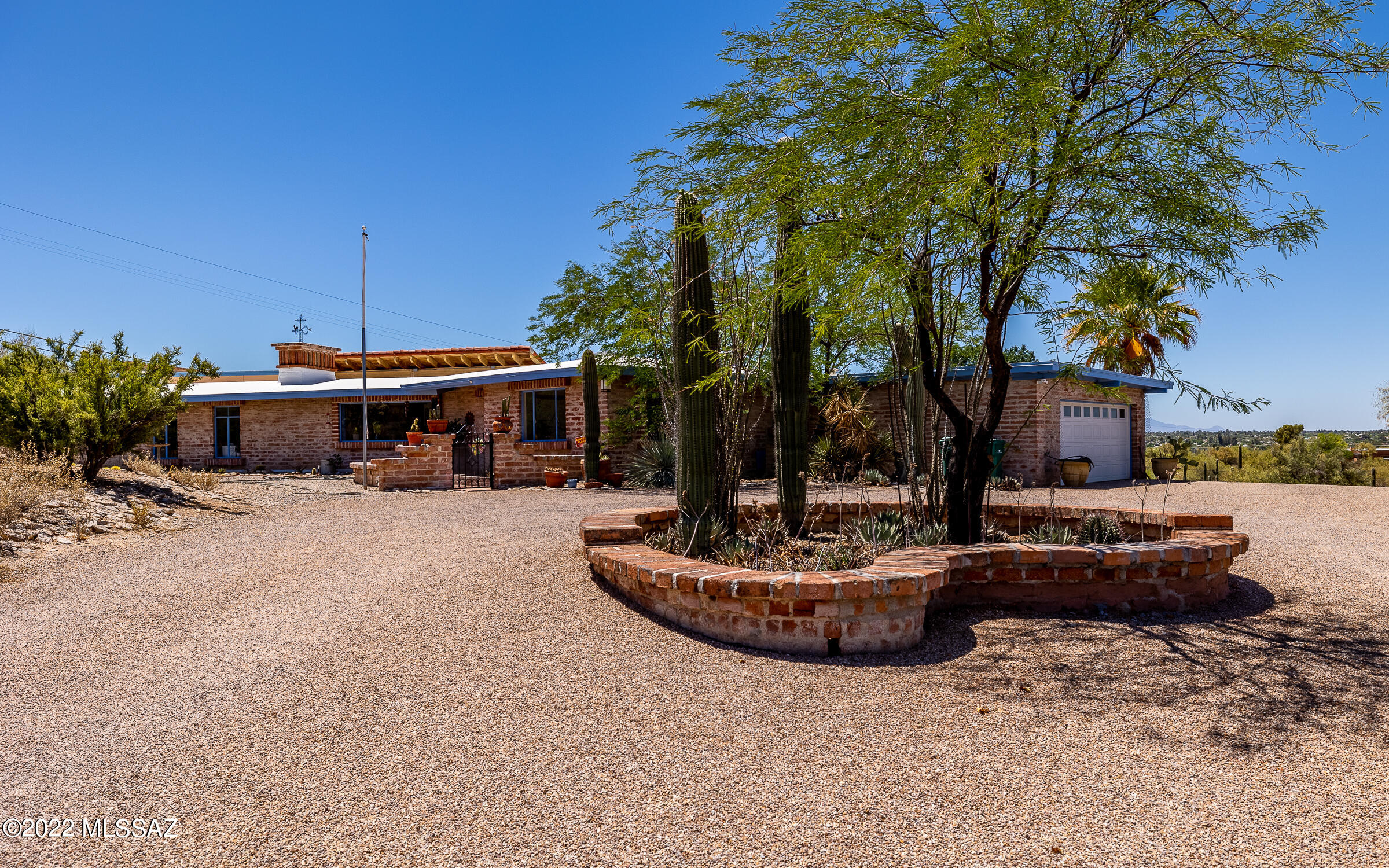 Unique custom designed home on secluded 3.9 acre parcel highlighting excellent 270 degree city/mountain views.  Lots of  beautiful wood wall and ceiling treatments.  Huge glass picture windows throughout as well as skylights to brighten the home.  Bonus detached 4-car garage/workshop area.  Plenty of room to add RV storage facility.  Well maintained.  No HOA.  Pima County codes apply.