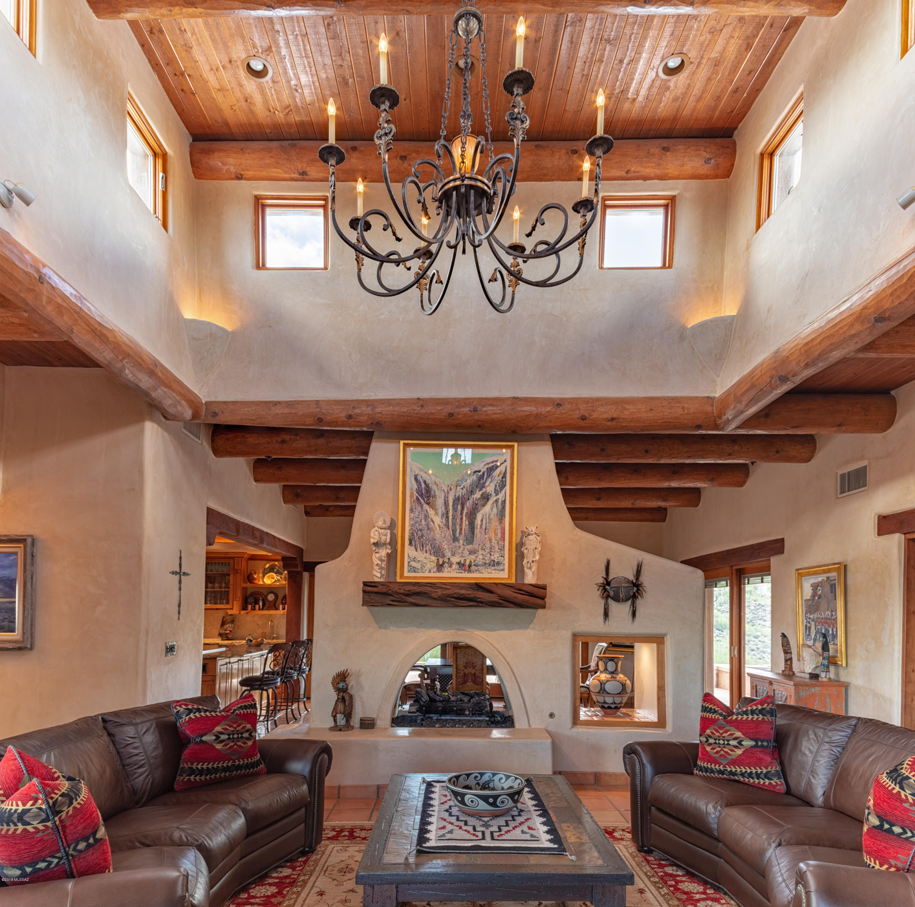 SET HIGH ON A HILL WITH COMMANDING MOUNTAIN AND CITY VIEWS this exquisite 2006 custom-built adobe hacienda has been sculpted in harmony with its 10 (or 20) private acres. This rare, quality home was built with careful consideration to the contours of the land, and the energy-efficient structure envelops you and your guests in a warm and peaceful way that only traditional adobe construction affords. An ideal property for southwest living with marvelous guest quarters for family and friends to gather! This home was built for comfortable living and entertaining; plenty of places to flow inside and out yet you can still maintain quiet conversations in numerous seating areas. The total 4457 sq ft of living space has been tastefully appointed with creamy Venetian plaster walls, soaring ceilings with hand hewn viga beams, kiva fireplaces, polished concrete and saltillo tile floors, custom cabinetry, and wood casement Pella windows and doors. In the 3563 sq ft main home, a gourmet kitchen, combined with built-in BBQs on the covered patio, will thrill any chef.  Enjoy views of the Tucson Mountain range while seated in your dining room, or cozy up by the fire in the open and airy living room. The master bedroom suite is an oasis of calm with a copper soaking tub, kiva fireplace and a relaxing view of the twinkling city lights. There is a spacious 2nd bedroom and bathroom, an intimate media room, separate office space, as well as a laundry and powder room. Enjoy the vistas of Saguaro National Park from the saltwater pool and spa, or star gaze while the fire crackles in the outdoor fireplace. Sunrises and sunsets from the margarita deck are spectacular. The sweet two-bedroom 894 sq ft casita and exterior one bedroom studio/suite offer plenty of room for visiting family and friends, while allowing privacy for all. From the 3 car garage, you're only 15 minutes to town from this amazing property. This home is a treasure, and must be seen and felt to be appreciated.  You will not be disappointed!