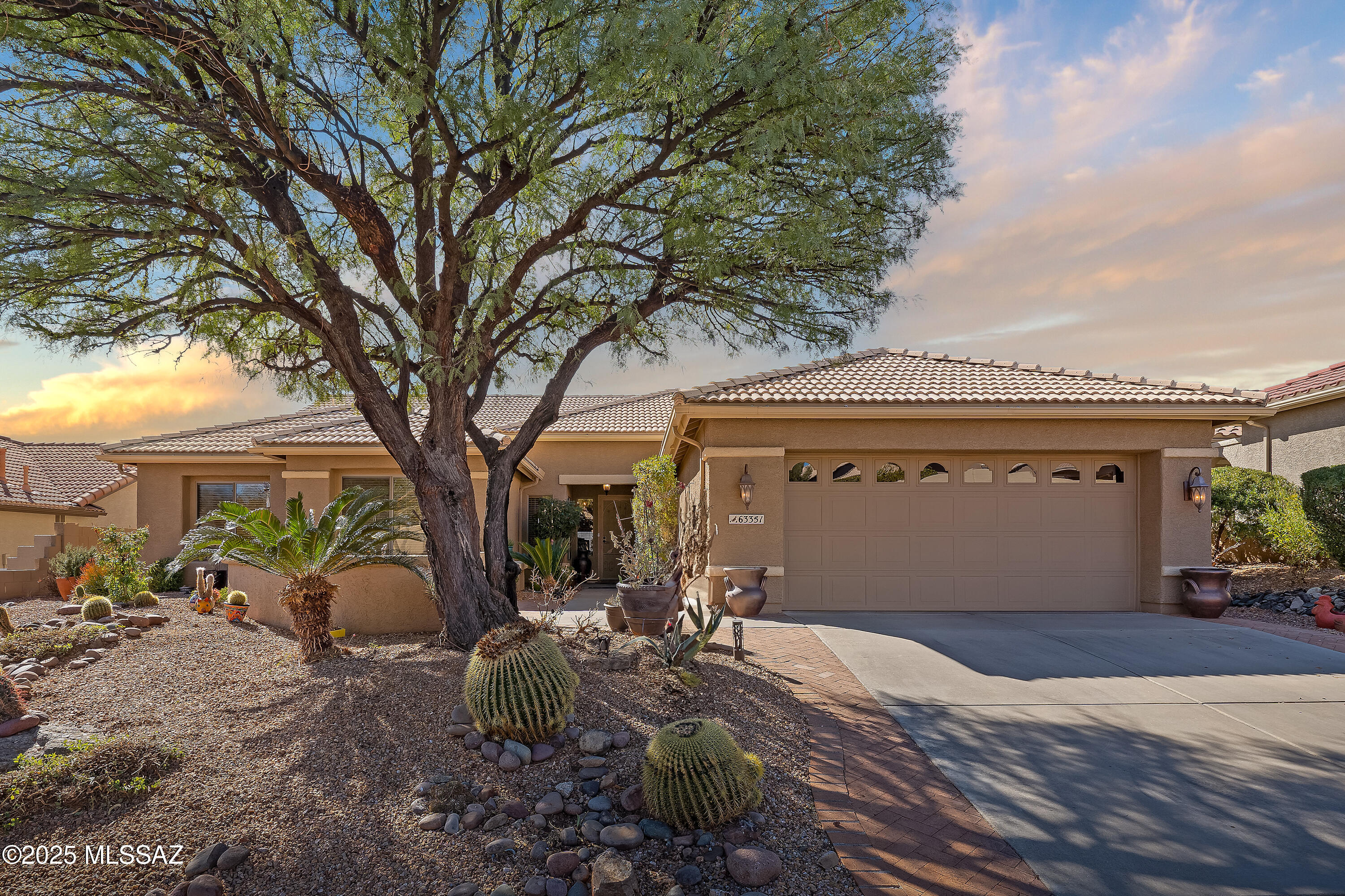 Motivated Seller. Bring us an offer! Magnificent Montana Model with Sweeping Catalina Mountain Views. The open floor plan, vaulted ceilings, & large windows create a light and airy ambiance. Great room design with gorgeous colored concrete floors and large dining area are perfect for entertaining.  Updated kitchen includes tons of cabinets, large island, quartz countertops, s/s appliances, and sunny breakfast nook. Primary suite with bay windows to capture the views, generous size primary bath has updated shower, double sink vanity and large walk in closet. Hall bath has new shower. Two additional bedrooms + den allows for plenty of room for family/guests & hobbies. Garage includes built in storage cabinets as well. Enjoy the wonderful views and privacy from your fabulous outdoor living space with a large covered patio. Extended brick paver patio, low care landscaping, and motorized sun shades make this the perfect place to relax and unwind. This move in ready home is not to be missed!